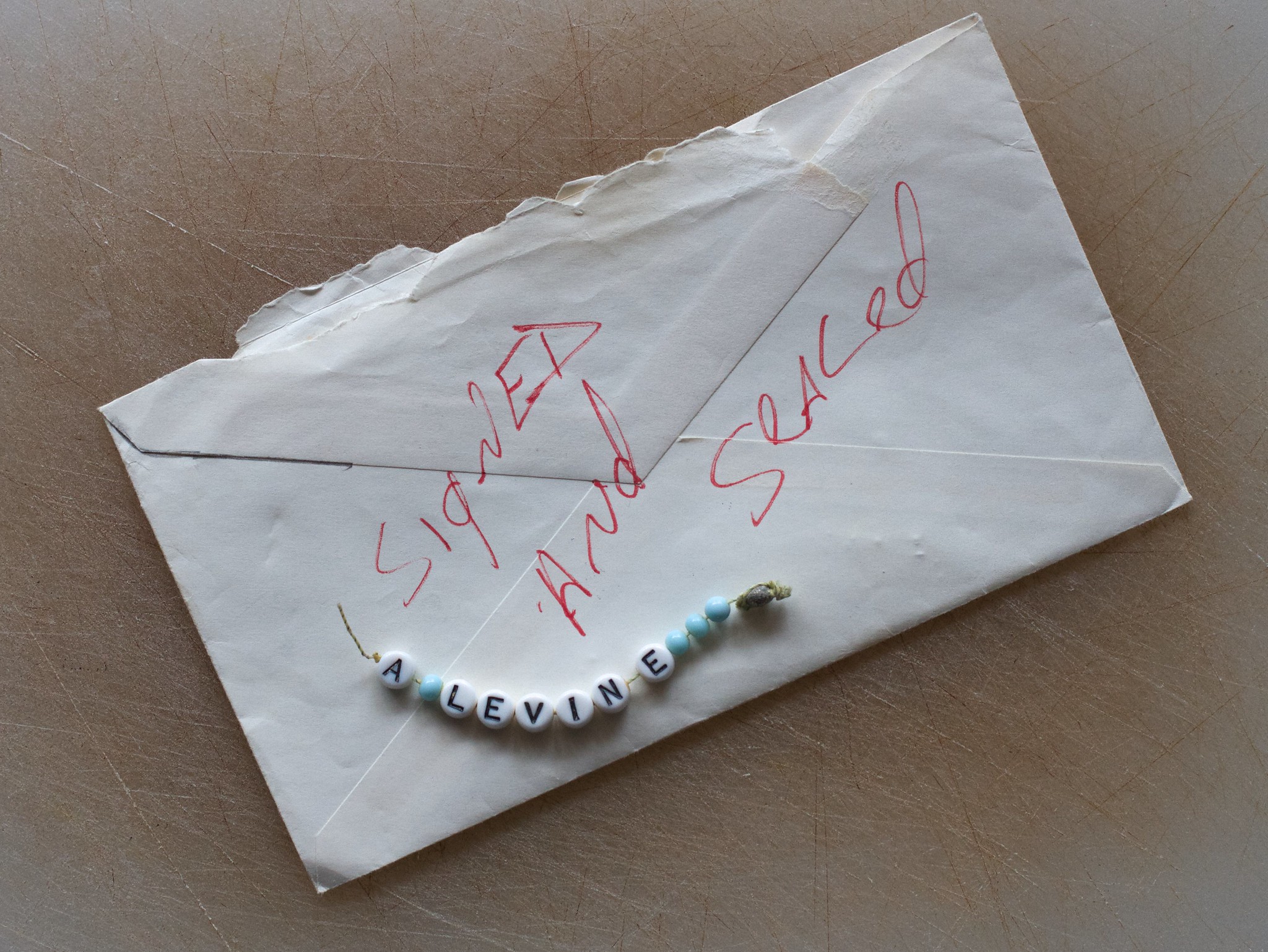 An envelope with a bracelet on top | Source: Flickr
