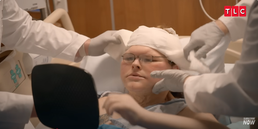 Tammy gazes into the mirror, reacting to her post-surgery transformation, from a video posted on June 11, 2025 | Source: YouTube/AccessHollywood