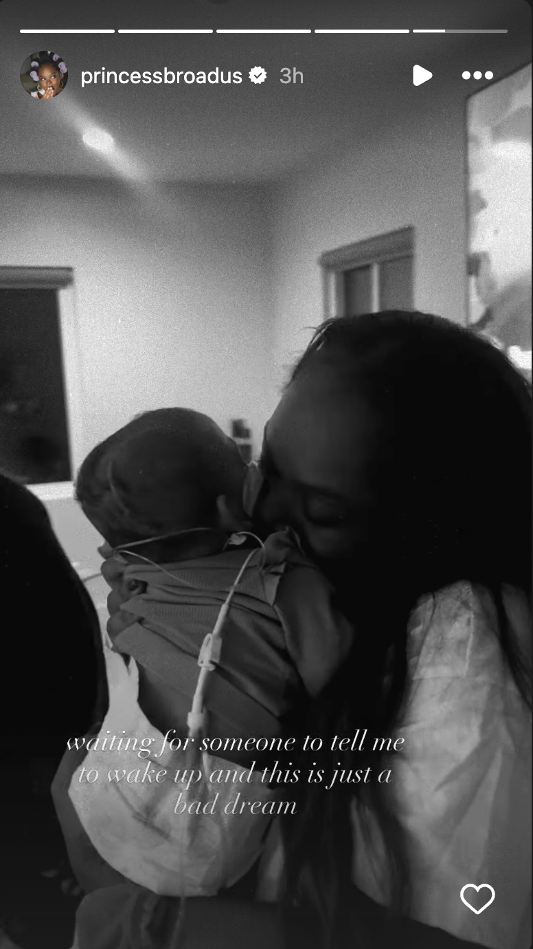 Cori Broadus cradles her newborn in a hospital room, with medical tubing and equipment visible in the background | Source: Instagram/princessbroadus