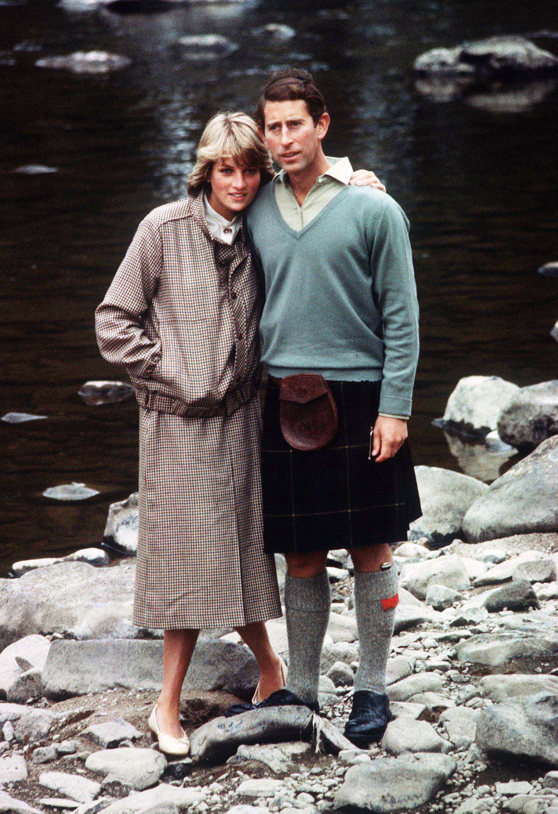 Prince Charles and Princess Diana pose for a photo on the banks of the river Dee in the grounds of Balmoral Castle during their honeymoon on August 19, 1981, in Balmoral, Scotland. | Source: Getty Images.