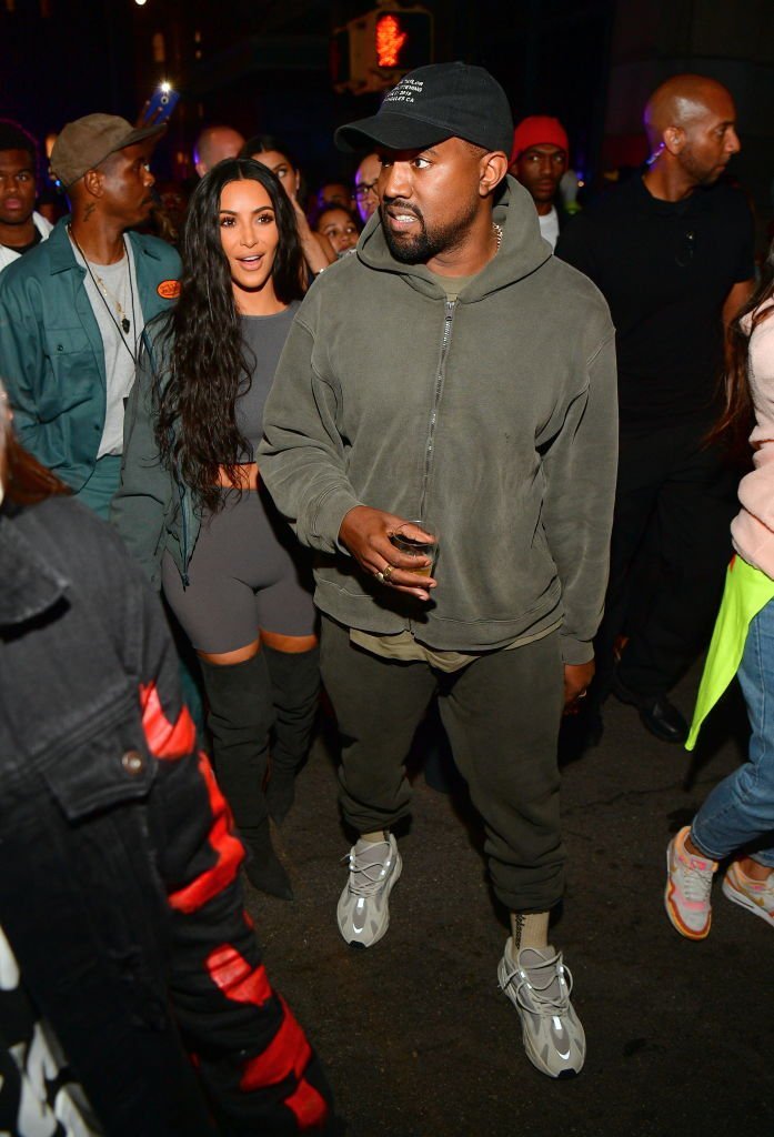 Kim Kardashian and her husband Kanye West wearing his Yeezys at an album release party in June 2018. | Photo: Getty Images 