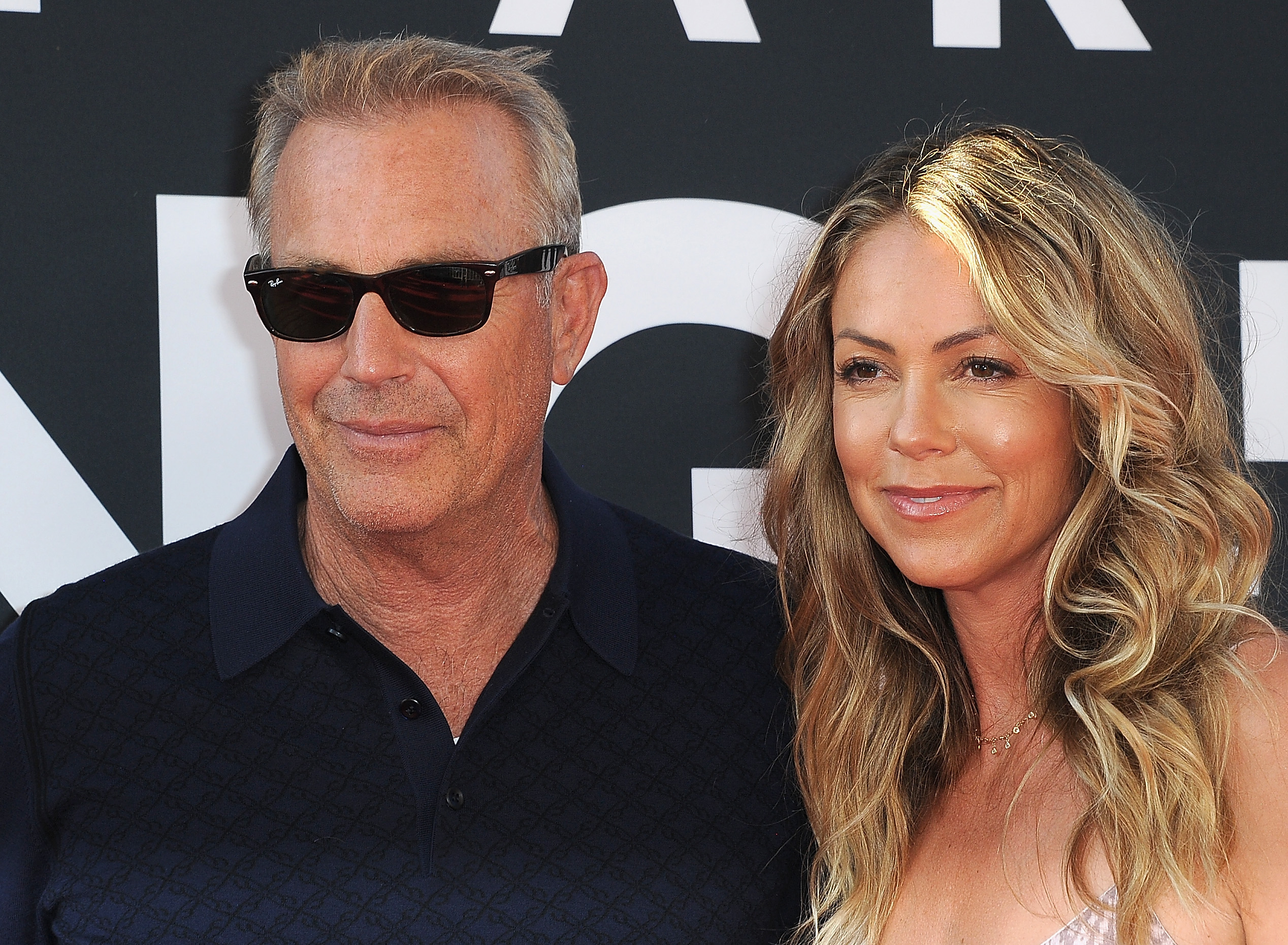 Kevin Costner and Christine Baumgartner pose at the Premiere Of 20th Century Fox's "The Art Of Racing In The Rain" at El Capitan Theatre on August 1, 2019, in Los Angeles, California | Source: Getty Images