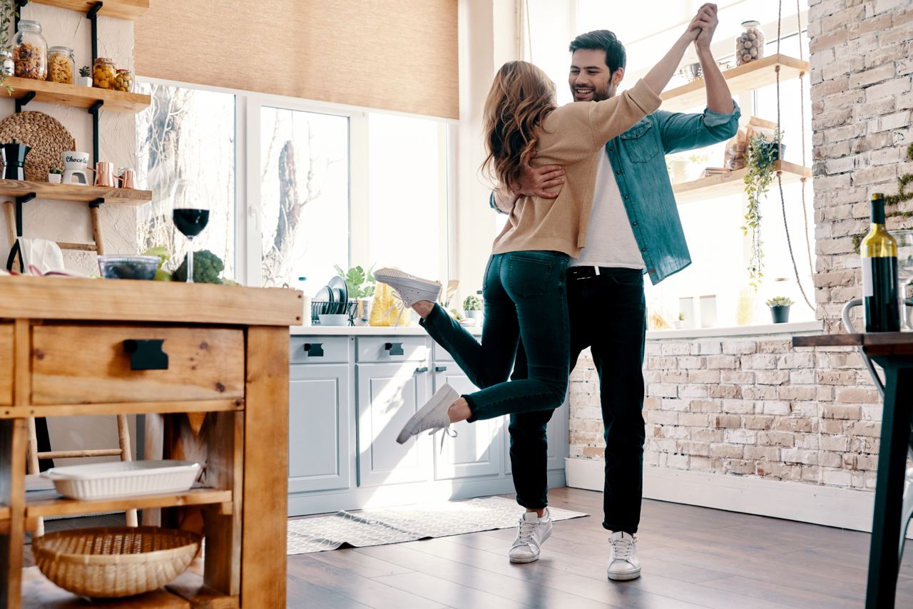 A couple is dancing at home | Source: Shutterstock