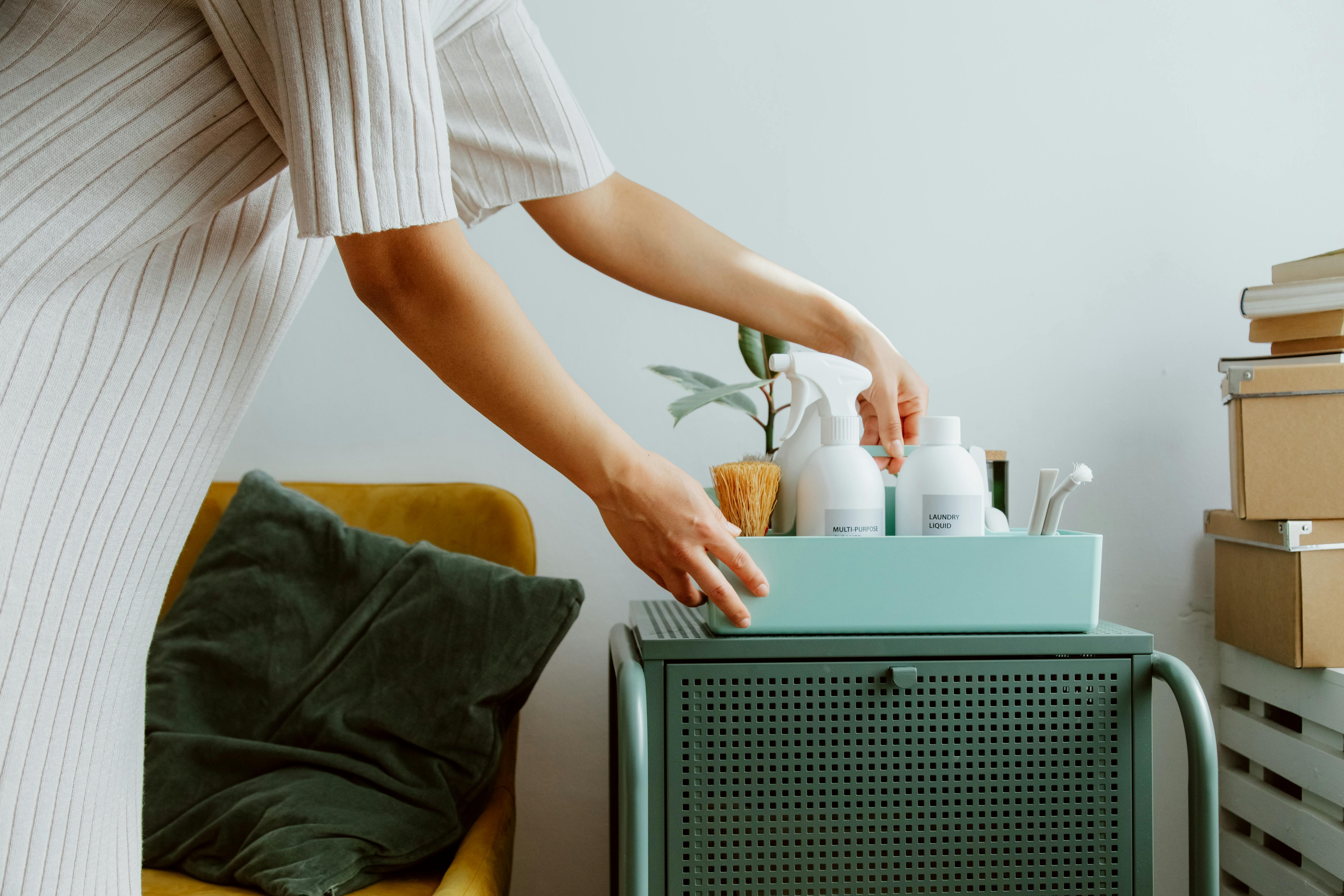 A woman organizing her laundry cabinet | Source: Pexels