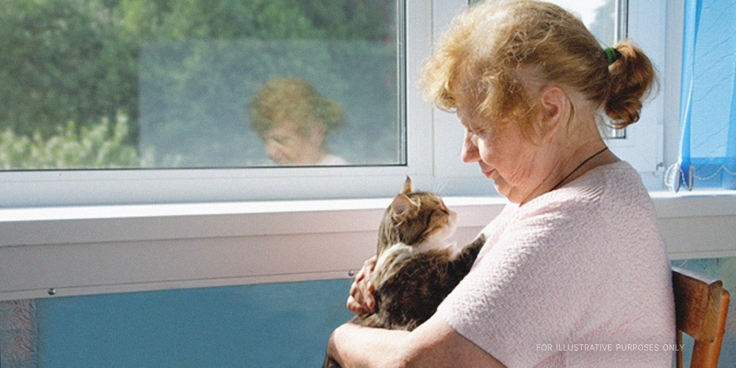 An old woman holding a cat. | Source: Shutterstock