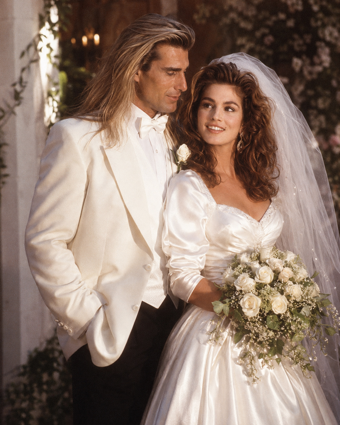 This AI creation depicts Fabio in a white tuxedo jacket gazing at Cindy Crawford in a traditional satin bridal gown, evoking a lavish early 1990s wedding aesthetic. | Source: ChatGPT
