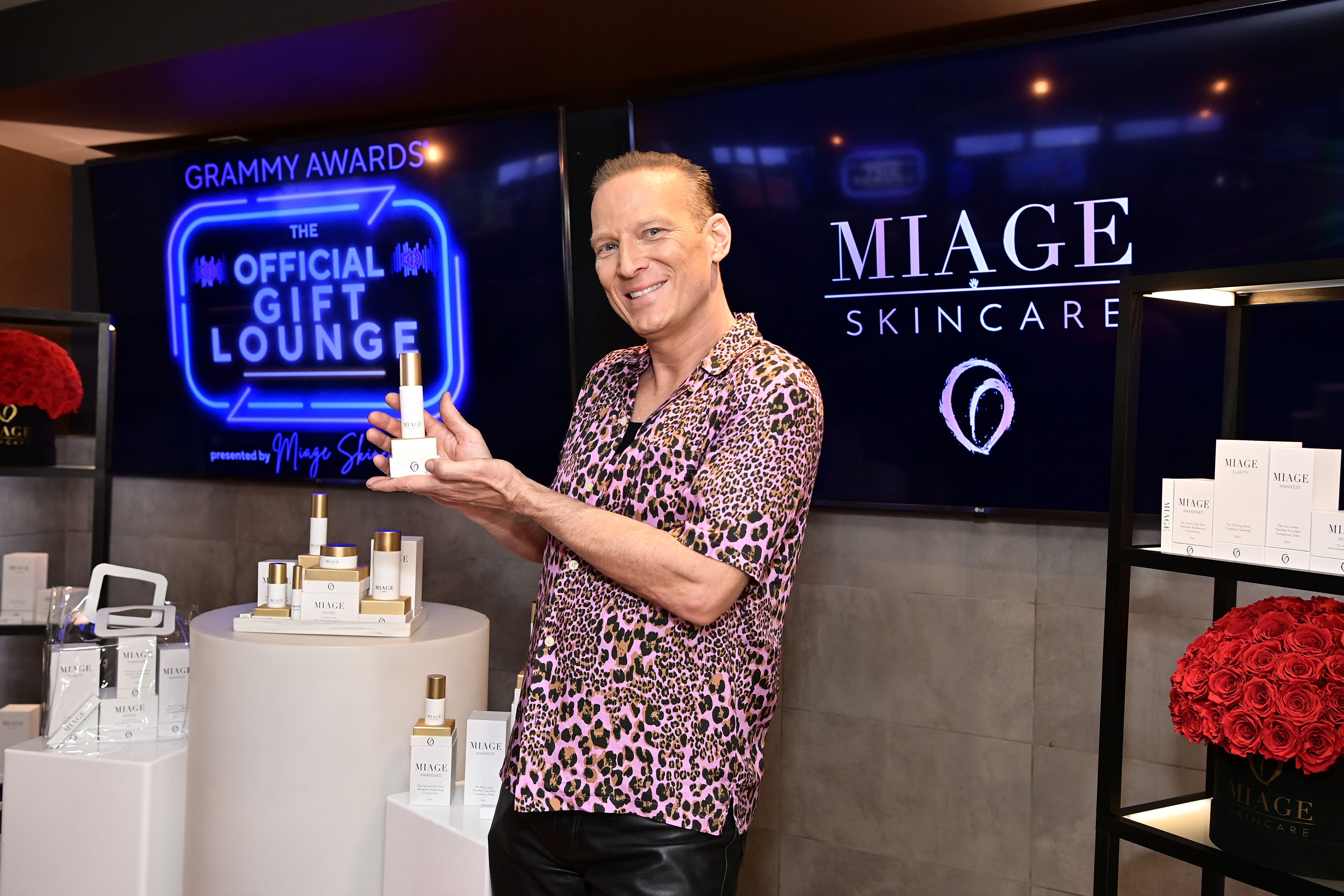 Lash Fary posing with some of the products included in Distinctive Assets gift bags. | Source: Getty Images