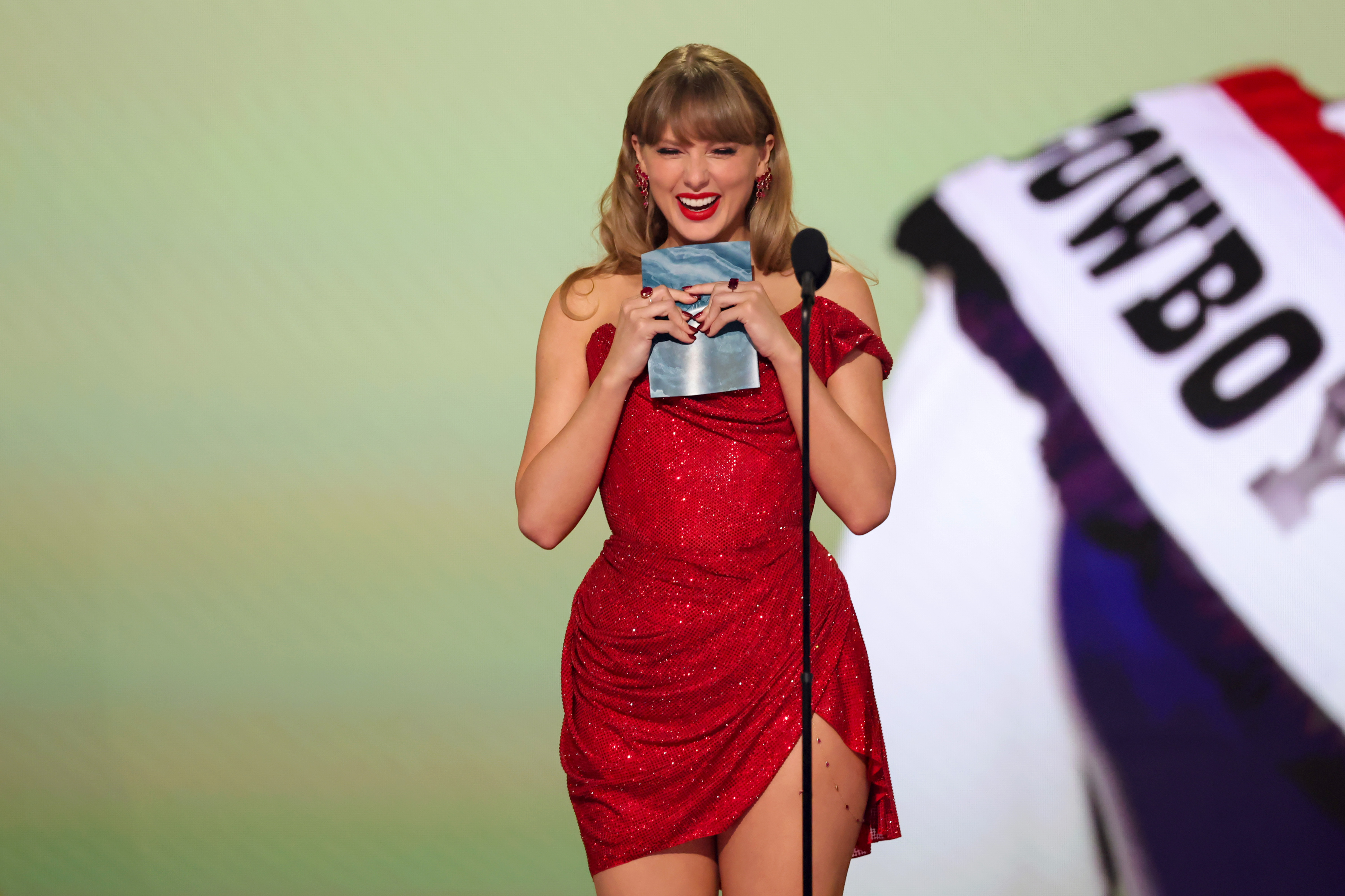 Taylor Swift speaking onstage at the 67th Annual Grammy Awards | Source: Getty Images