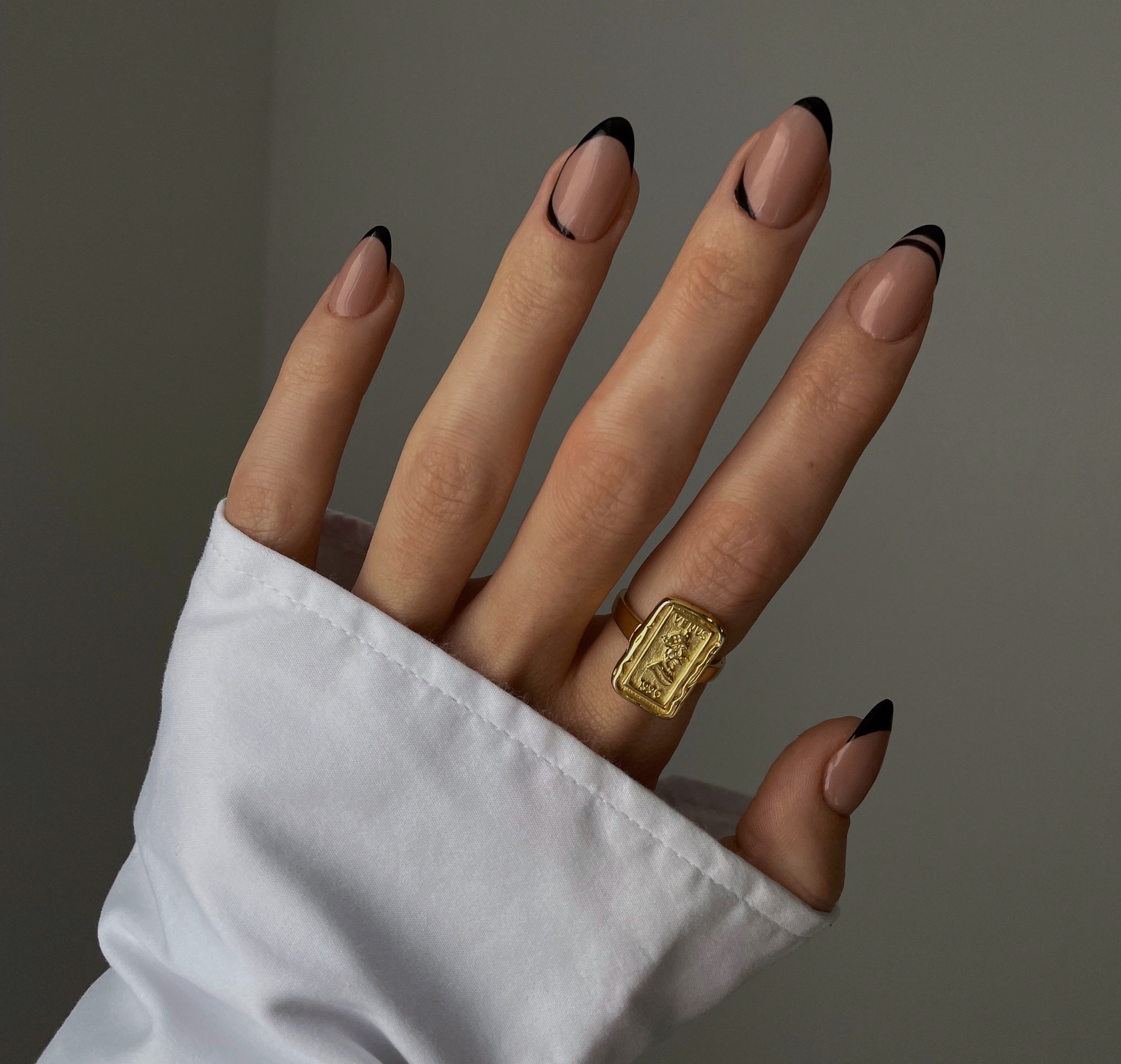 Elegant hand with Black Tip nails. | Source: Getty Images