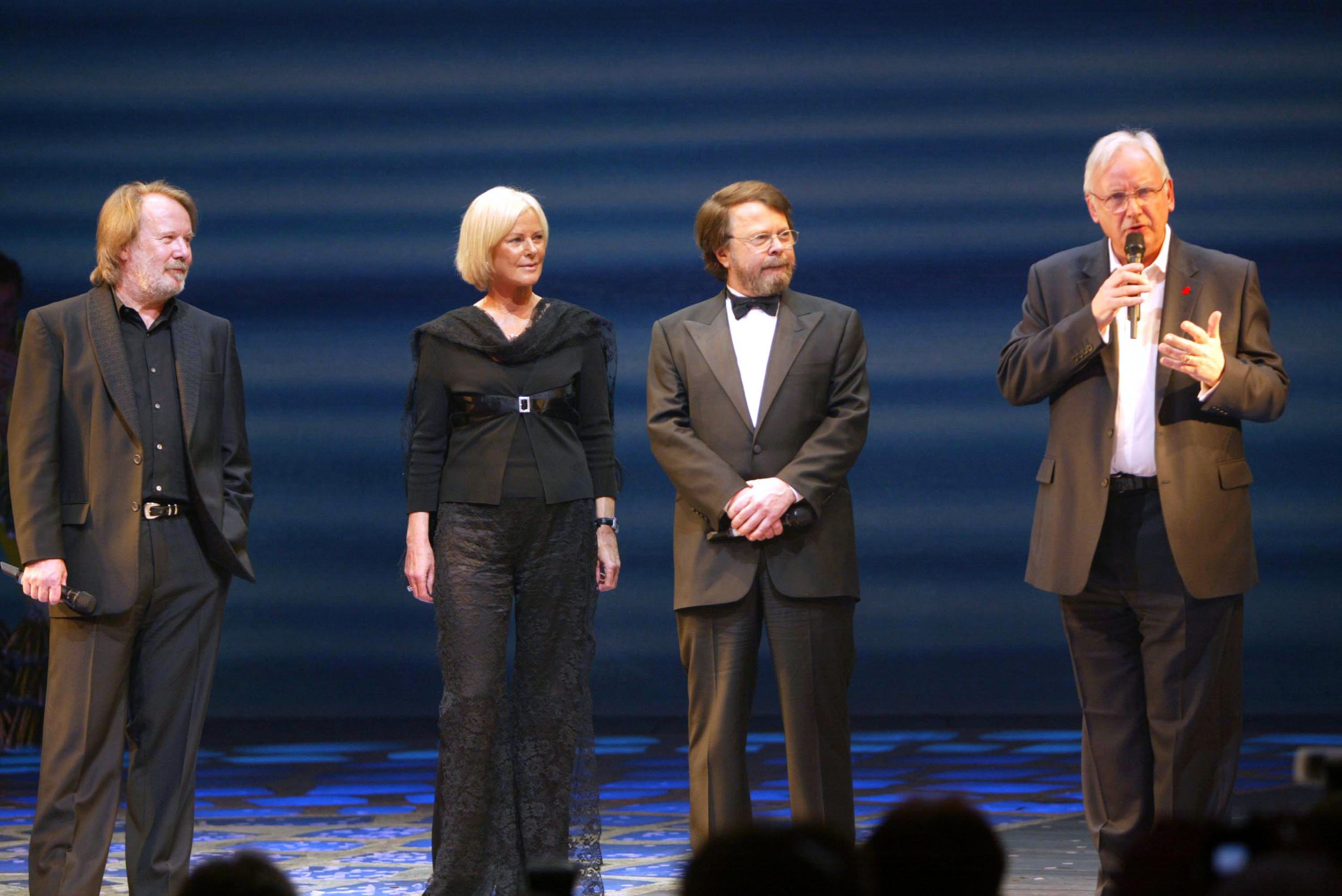 Benny Andersson, Frida Lyngstad, and Bjorn Ulvaeus from ABBA join Pete Waterman on stage at the fifth-anniversary performance of "Mamma Mia!," a musical based on ABBA's hits at the Prince Edward Theatre in London, England, on April 6, 2004. | Source: Getty Images