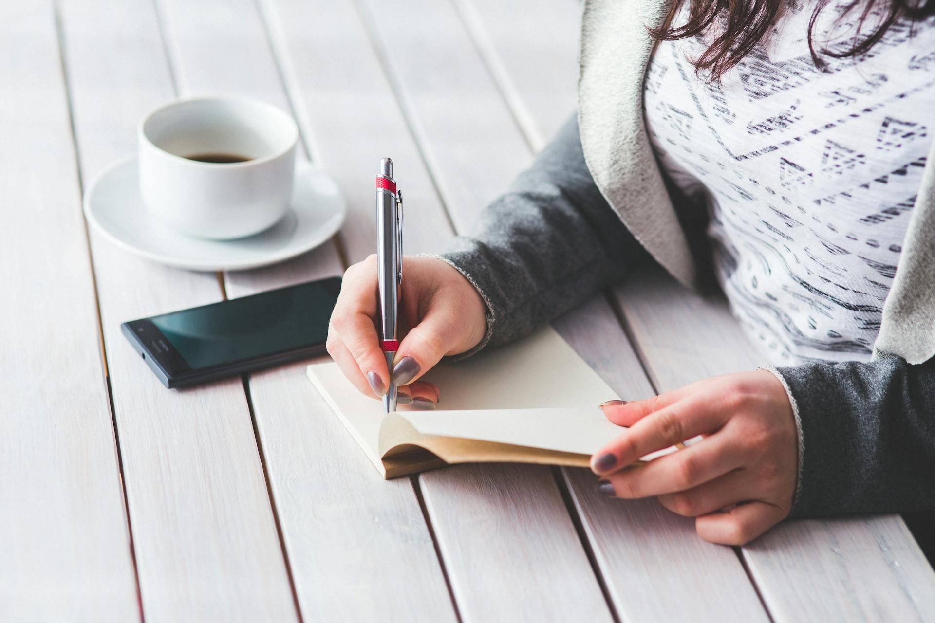 A woman making a note of things on her notepad | Source: Pexels