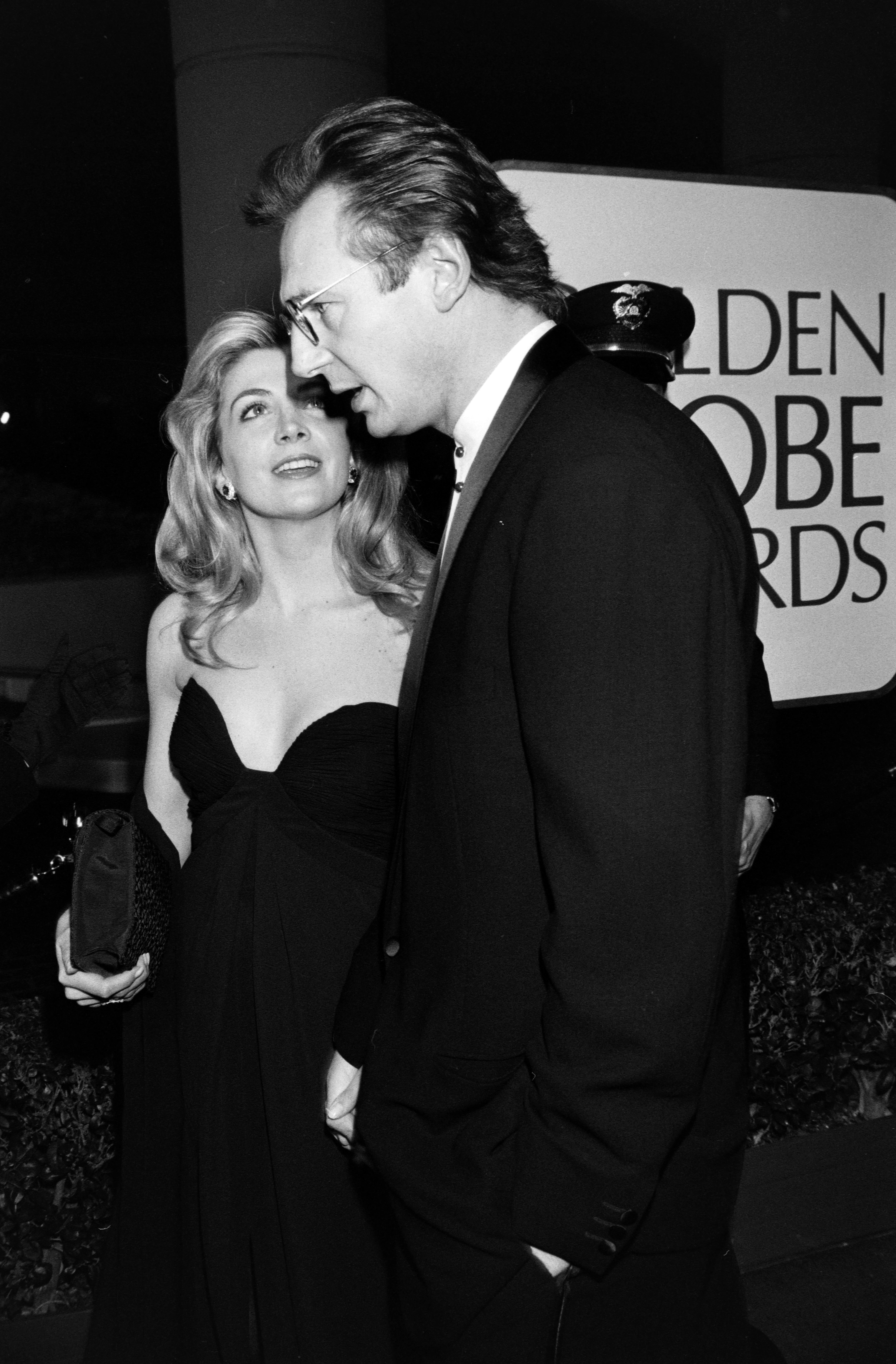 Natasha Richardson and Liam Neeson attend the 51st Annual Golden Globe Awards at the Beverly Hilton Hotel on January 22, 1994. The couple stands close together on the red carpet, with Richardson looking up toward Neeson as they prepare to pose for photos.
