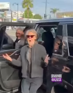 In a more animated moment, Paul McCartney gestured with both hands as if addressing those around him, his expression lively and engaged. Taken from a post dated 28 March 2026, the candid frame highlighted his natural ease with fans, while his greying beard and relaxed styling reinforced the more carefree look he has embraced. | Source: Facebook/IWMBuzz