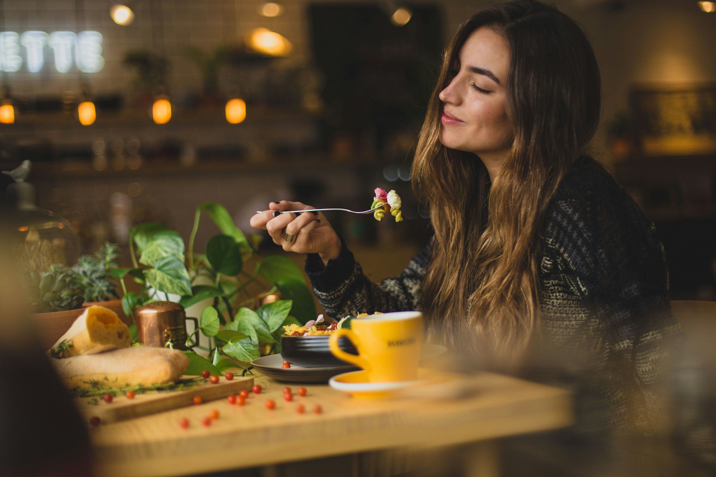 A woman enjoying dinner in a restaurant | Source: Unsplash