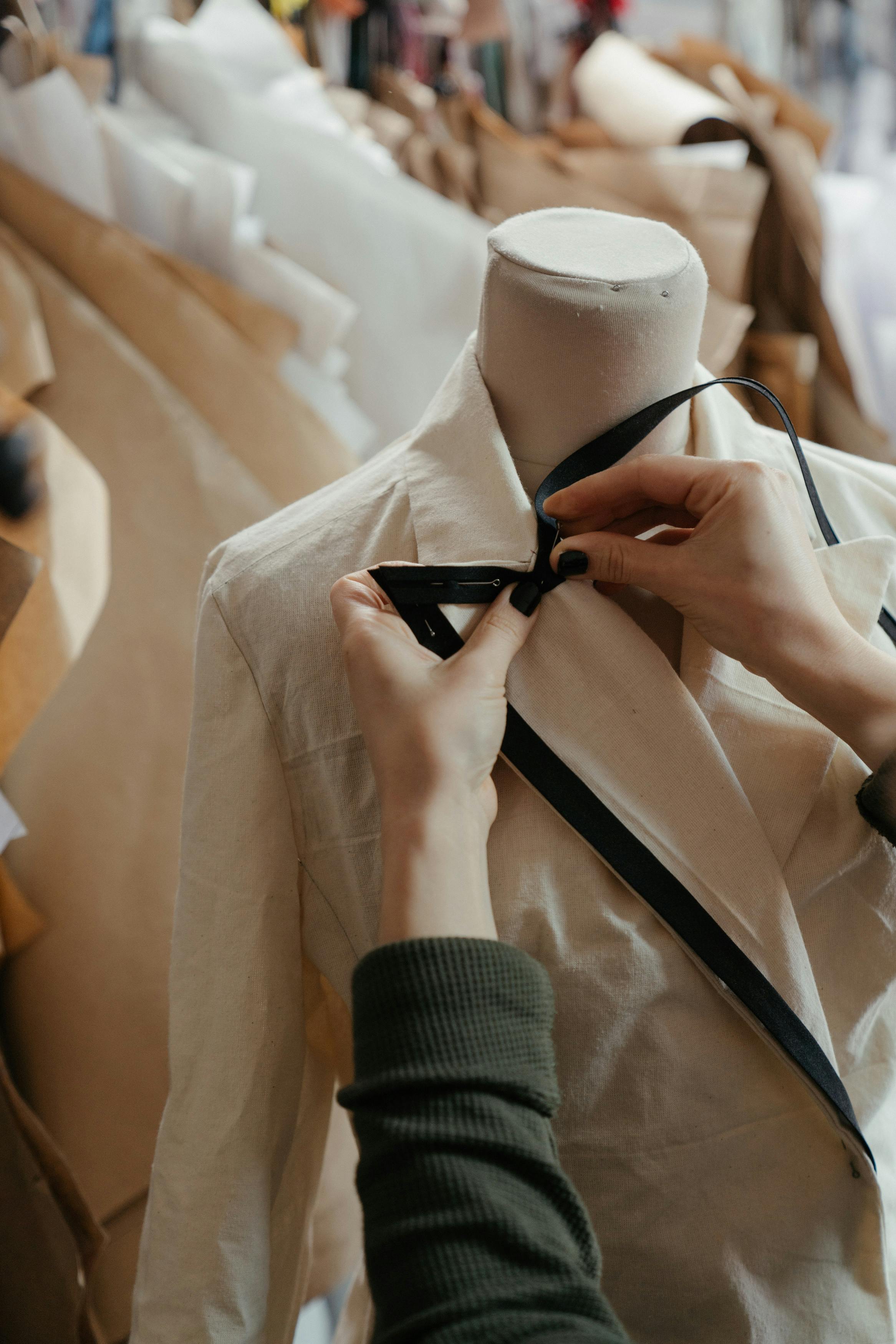 Hands working on a shirt | Source: Pexels