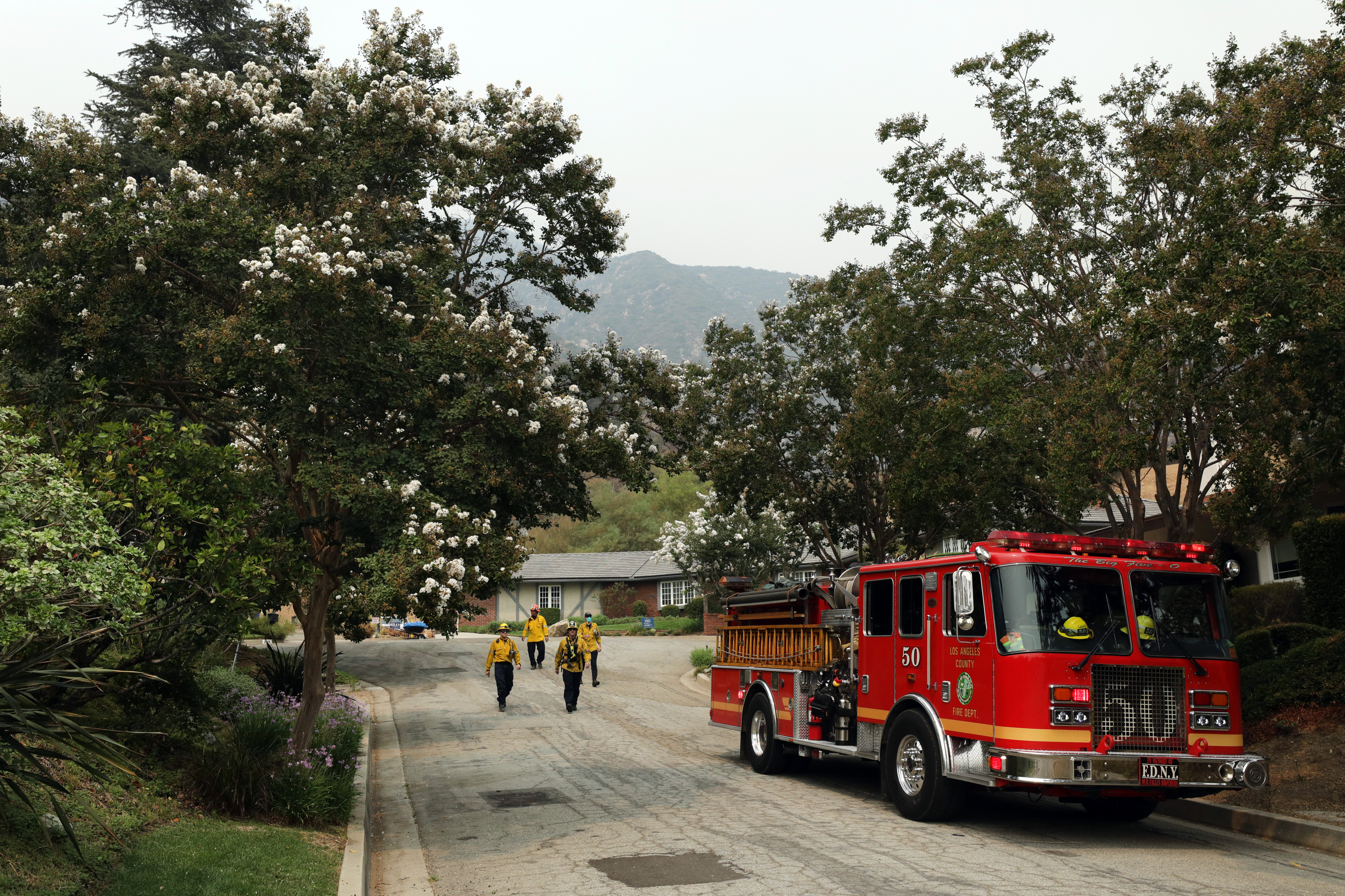 Firefighters inspect a Sierra Madre neighborhood near the Bobcat fire on Sept. 13, 2020. | Source: Getty Images