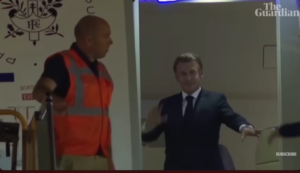 President Emmanuel Macron waves at the cameras | Source: YouTube/The Guardian