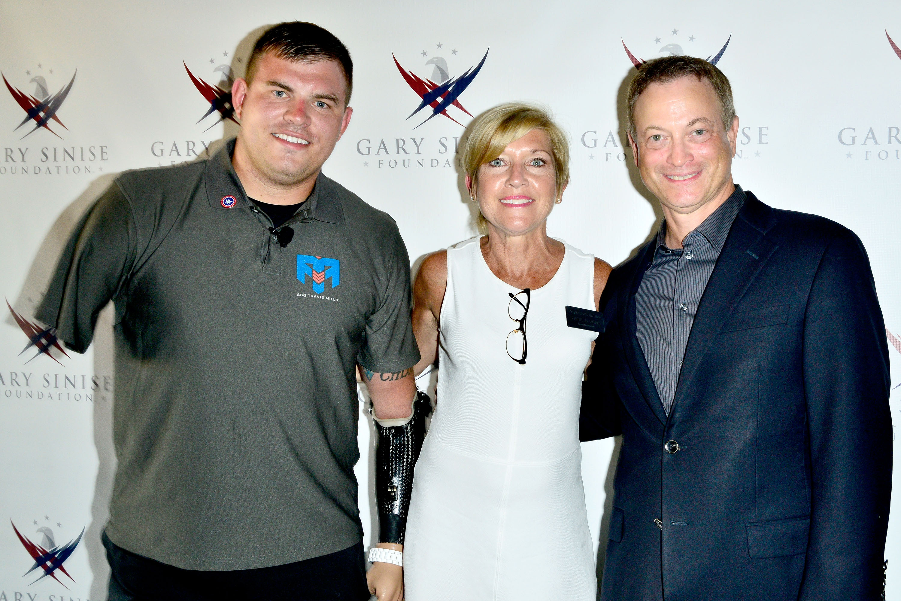Travis Mills, Executive Director of the Gary Sinise Foundation Judy Otter, and Gary Sinise attend 'Travis: A Soldier's Story' benefit screening in Coronado, California, on July 8, 2014. | Source: Getty Images