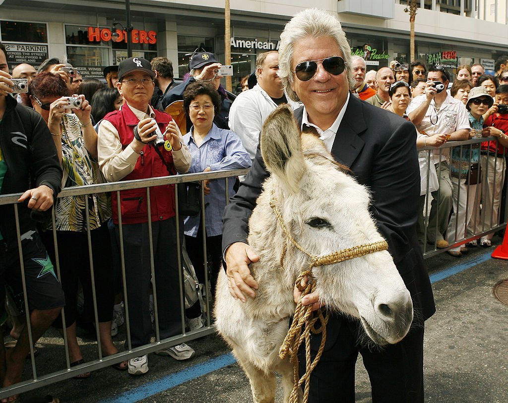 Producer John Peters poses with a burro at the ceremony honoring him with a star on the Hollywood Walk of Fame May 1, 2007. | Photo: Getty Images
