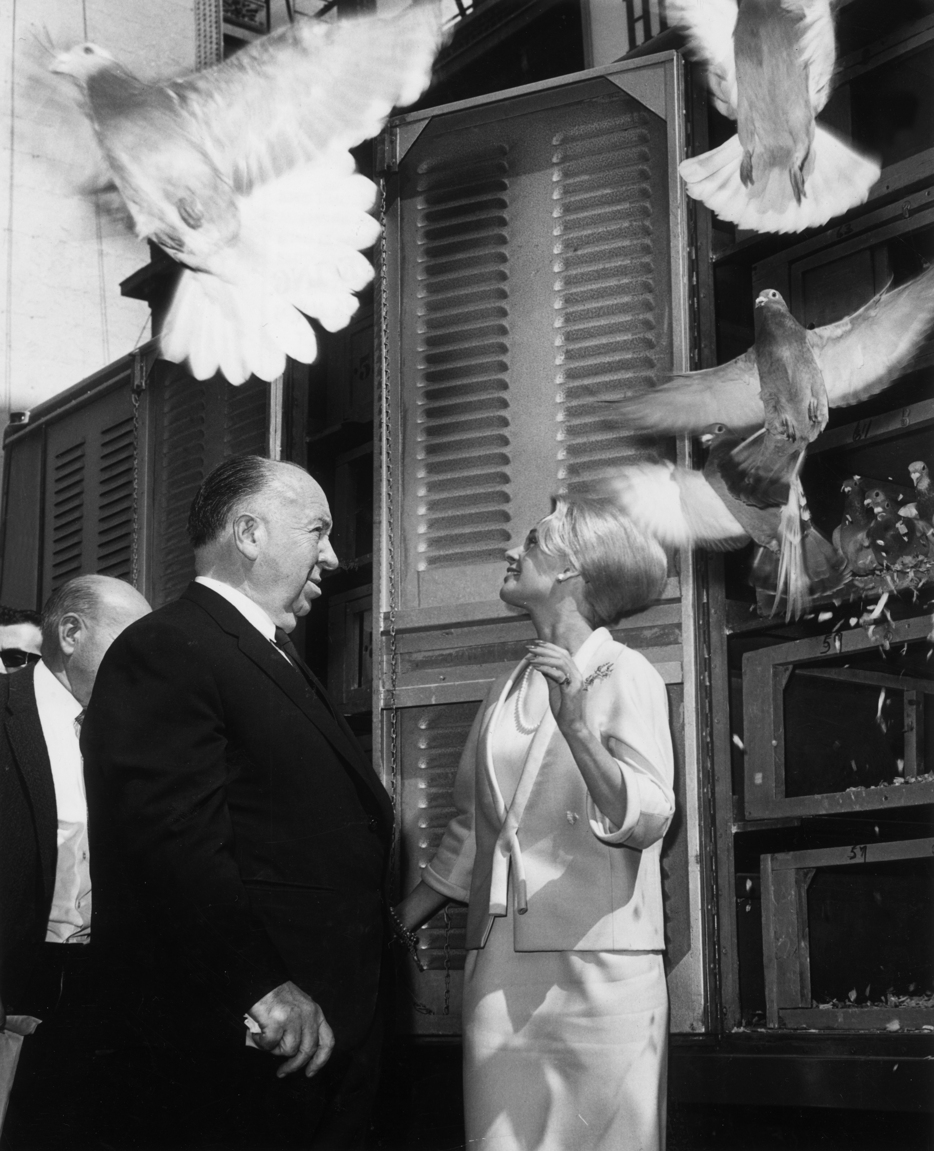 Alfred Hitchcock and Tippi Hedren release 1,000 pigeons to mark the opening of "The Birds" at the RKO Palace Theater in New York City in 1963. | Source: Getty Images