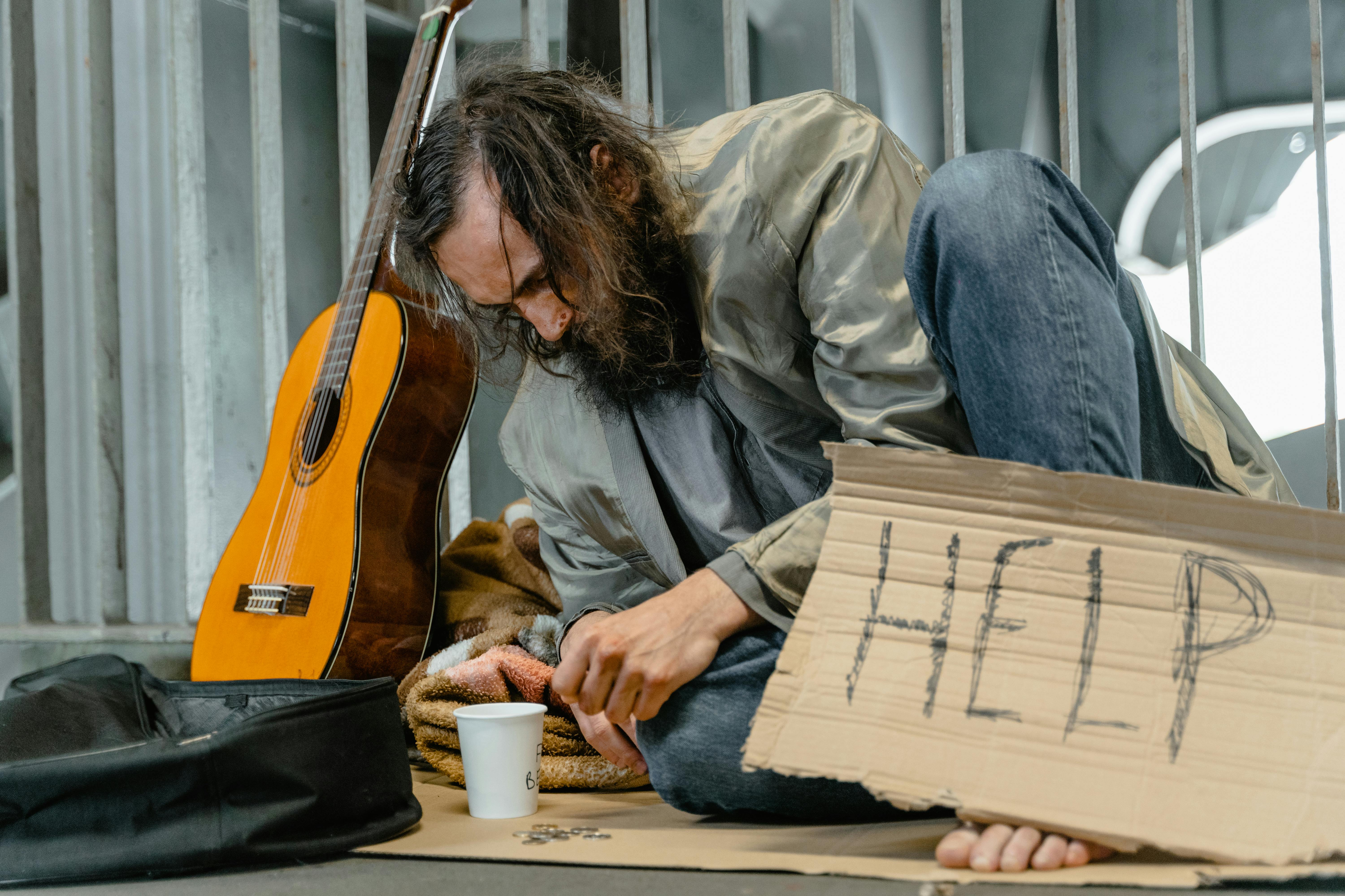 Homeless man with a sign | Source: Pexels