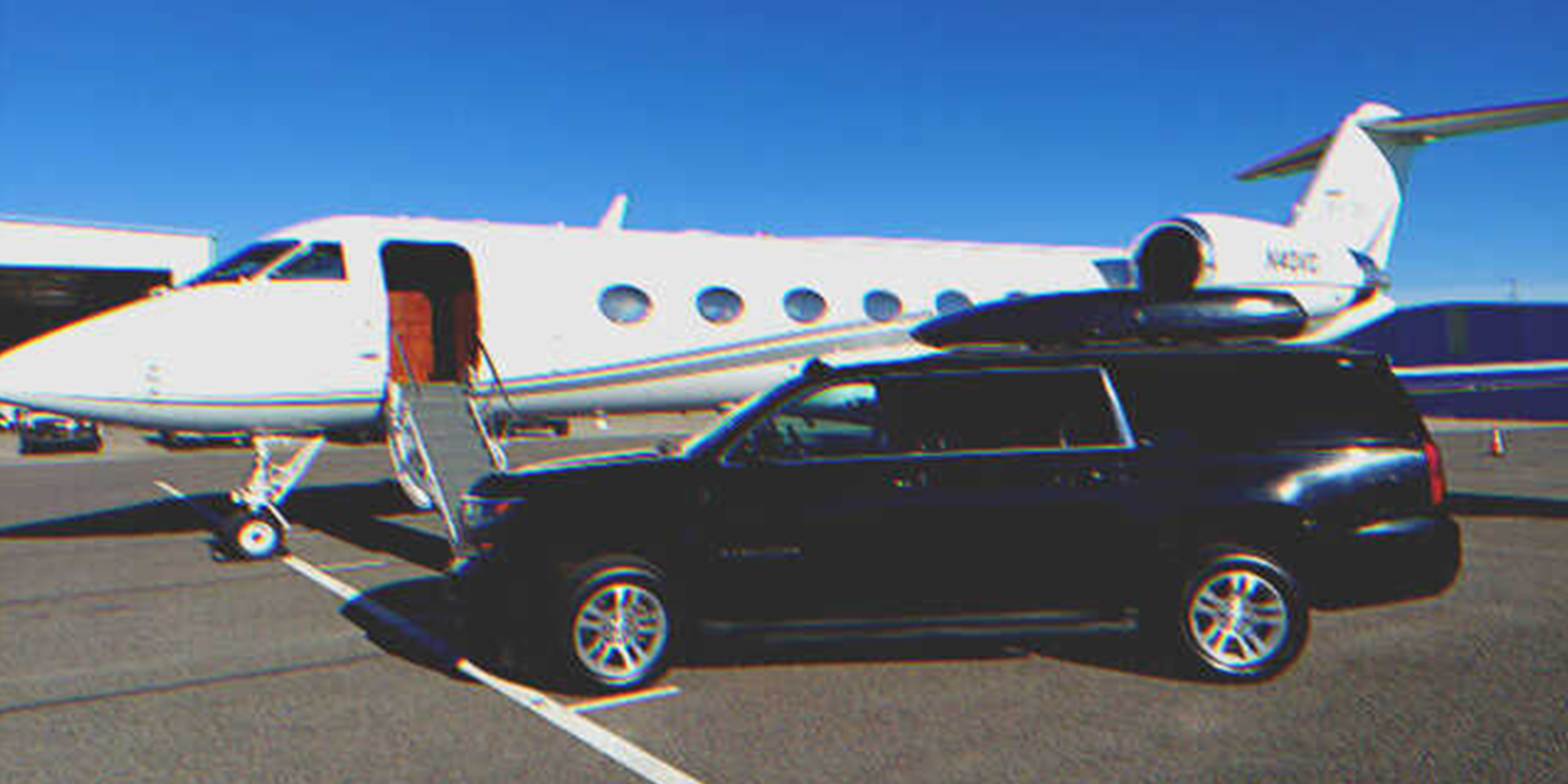 SUV parked beside private jet | Source: Shutterstock
