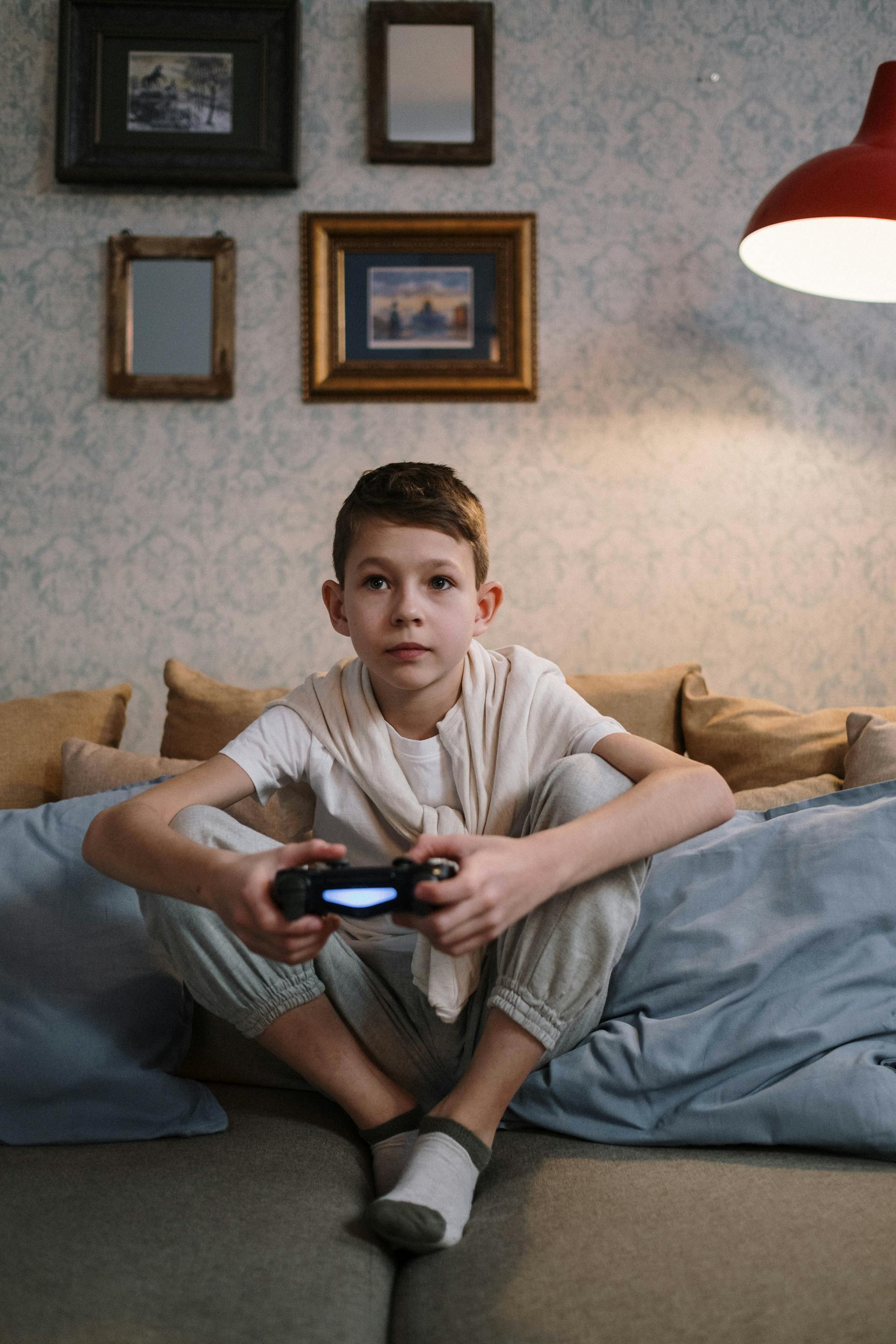 A boy holding a game console | Source: Pexels