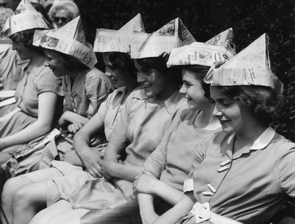  Schoolgirls wearing newspaper hats to protect them from the sun while watching Wimbledon during a heatwave | Source: Getty Images