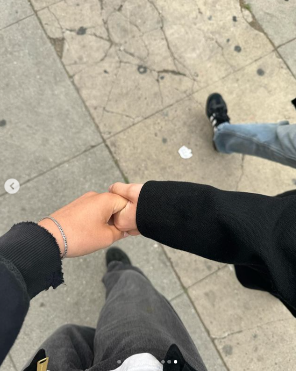 Anna Blundell and Louisa Jacobson hold hands as they walk on the street, as shared on Instagram in June 2024. | Source: Instagram/louisa_jacobson