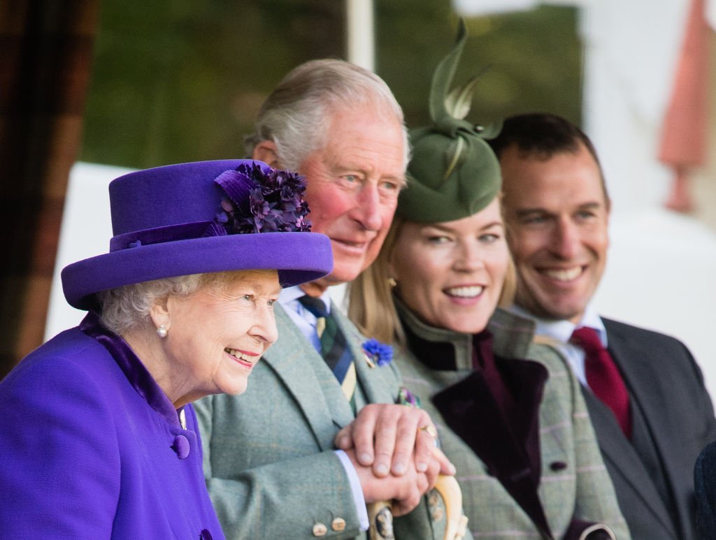 Queen Elizabeth , Prince Charles, Autumn Phillips and Peter Phillips sit front row at the 2019 Braemar Highland Games on September 07, 2019. | Photo: Getty Images