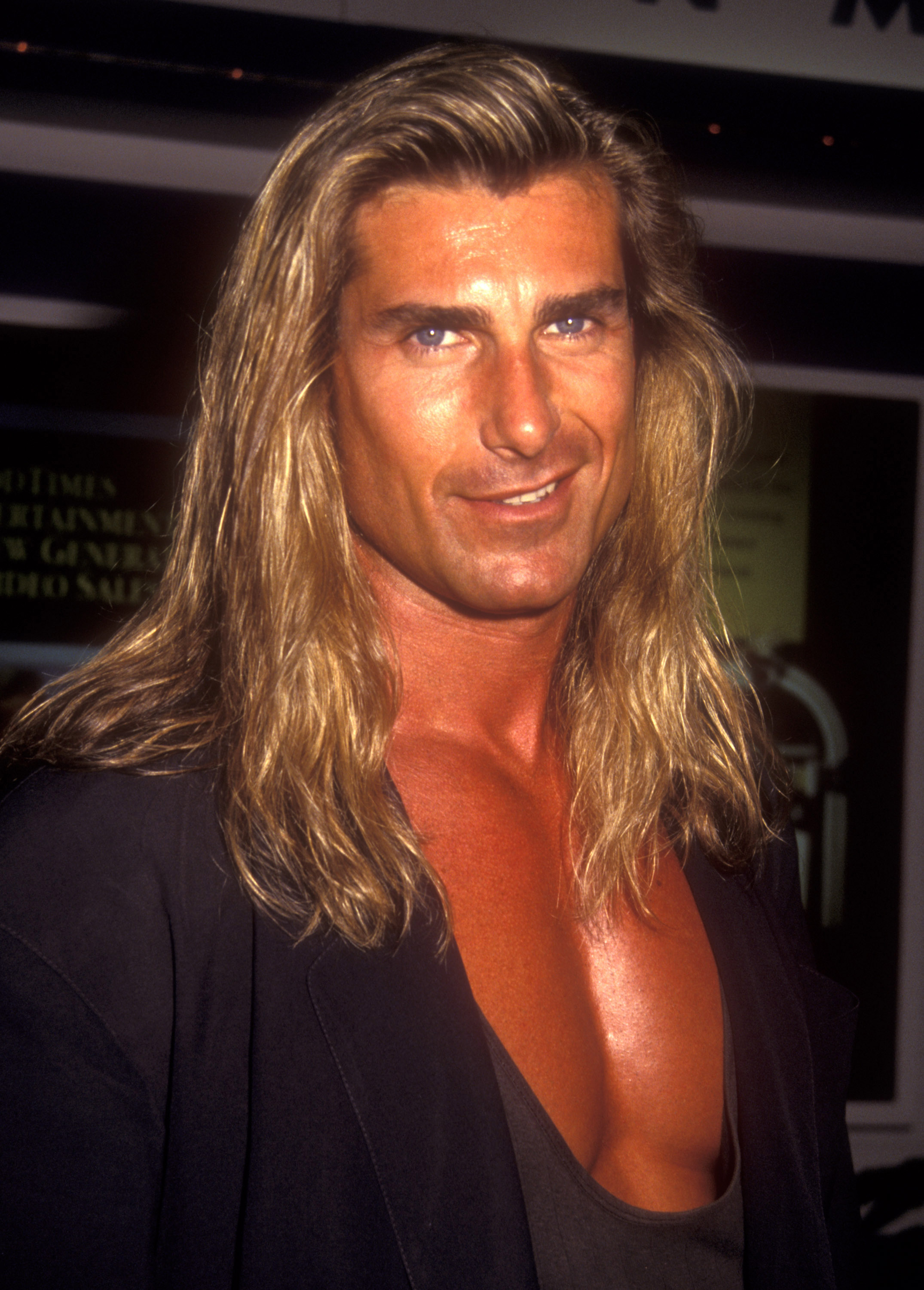 Let's rewind time and imagine through AI what he would have looked like alongside iconic women like Cindy Crawford, Pamela Anderson, and Heidi Klum. In this photo, Fabio attended the VSDA Convention on July 12, 1993. | Source: Getty Images