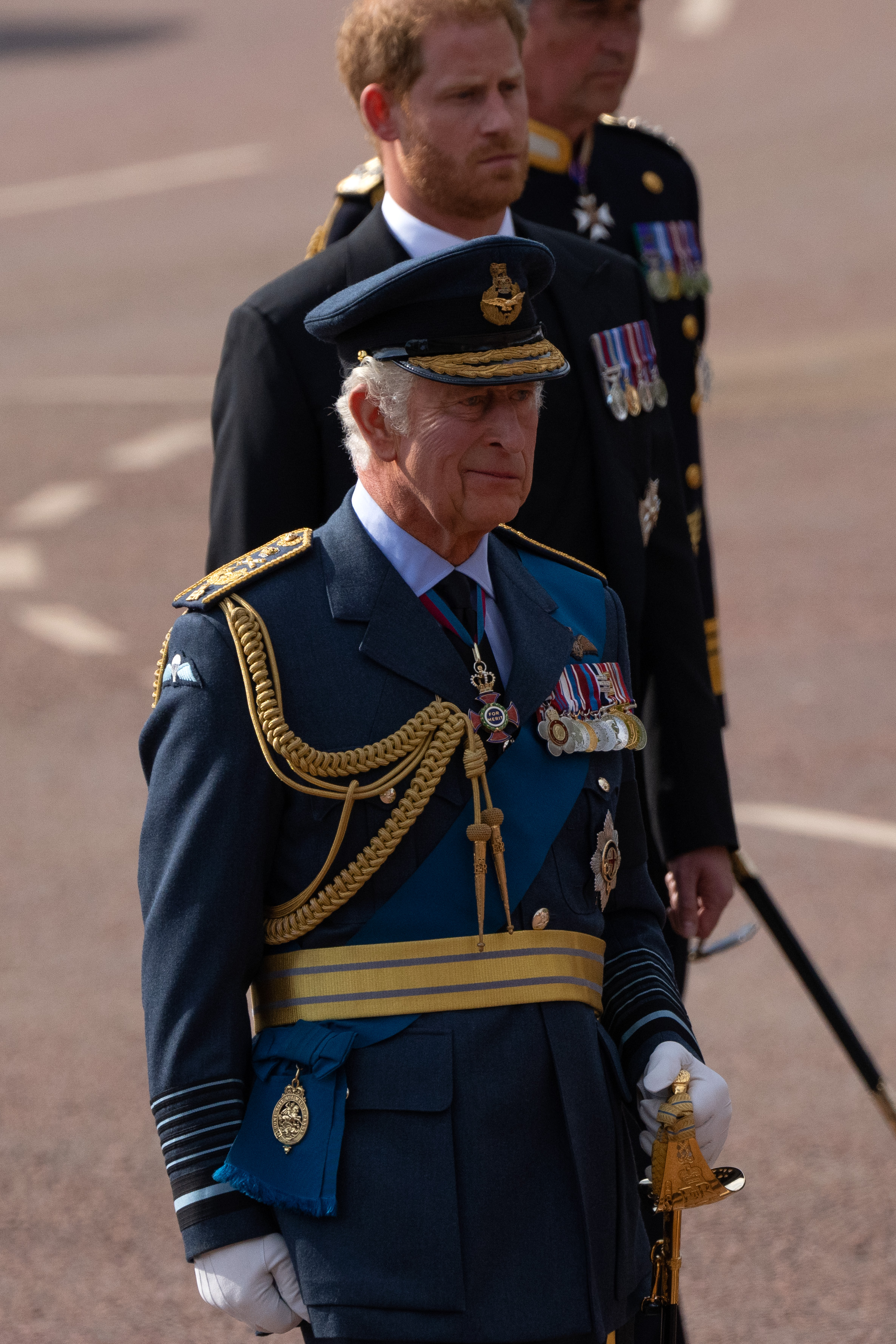 King Charles III stands before his son Prince Harry during the late Queen Elizabeth II's ceremonial procession in London, England on September 14, 2022. | Source: Getty Images