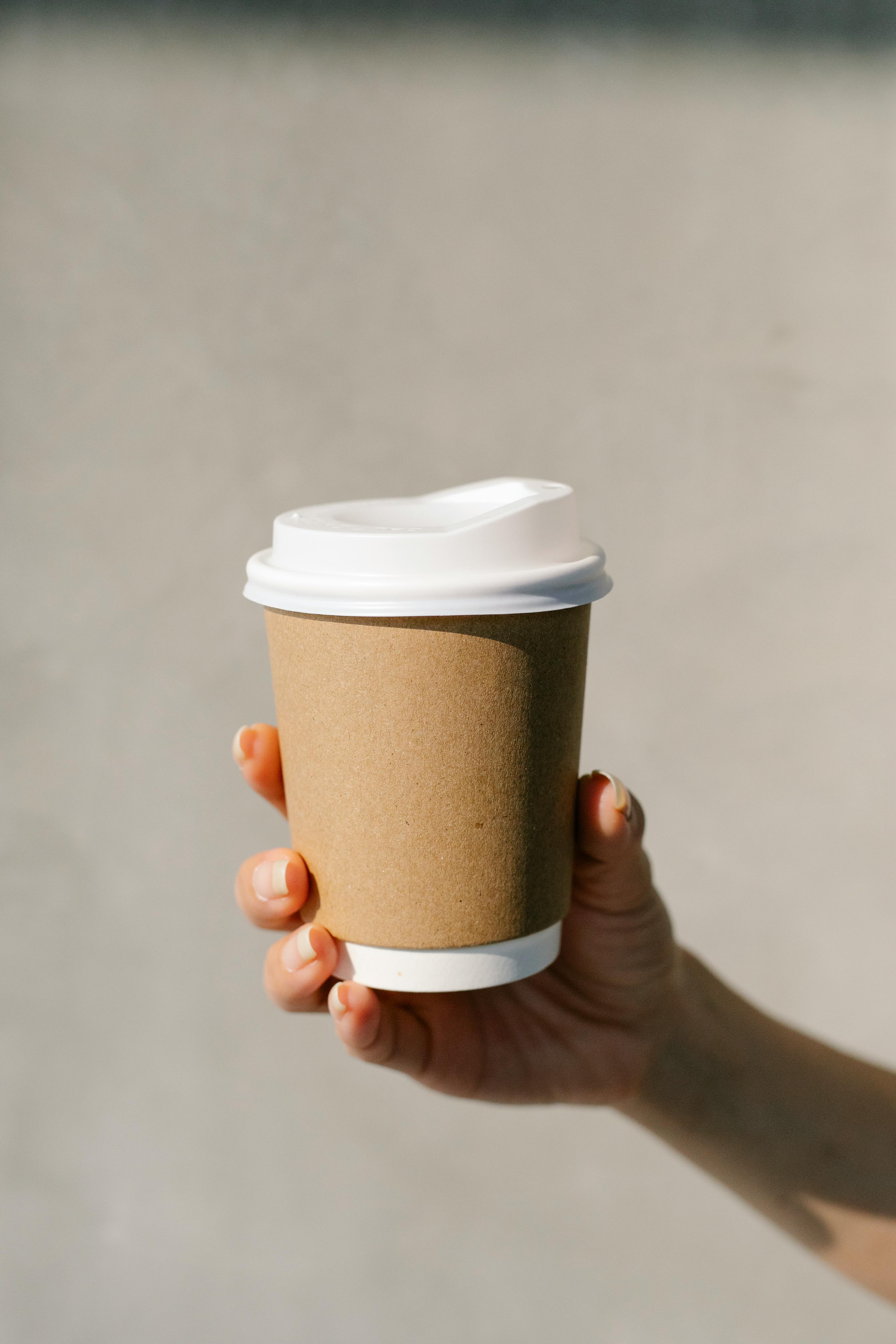A person holding a takeaway cup | Source: Pexels