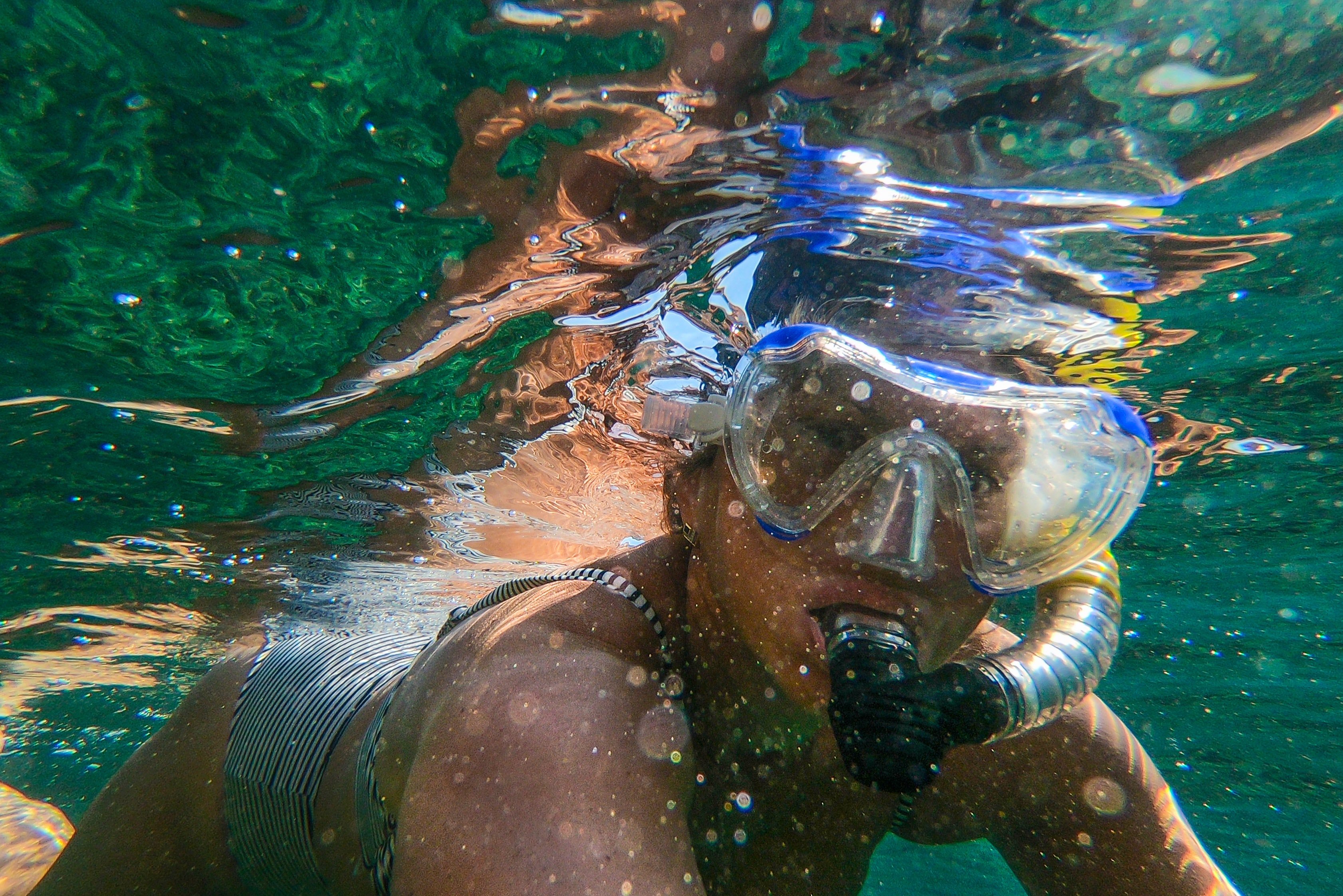 Pictured - A woman underwater wearing goggles and snorkel | Source: Pexels 