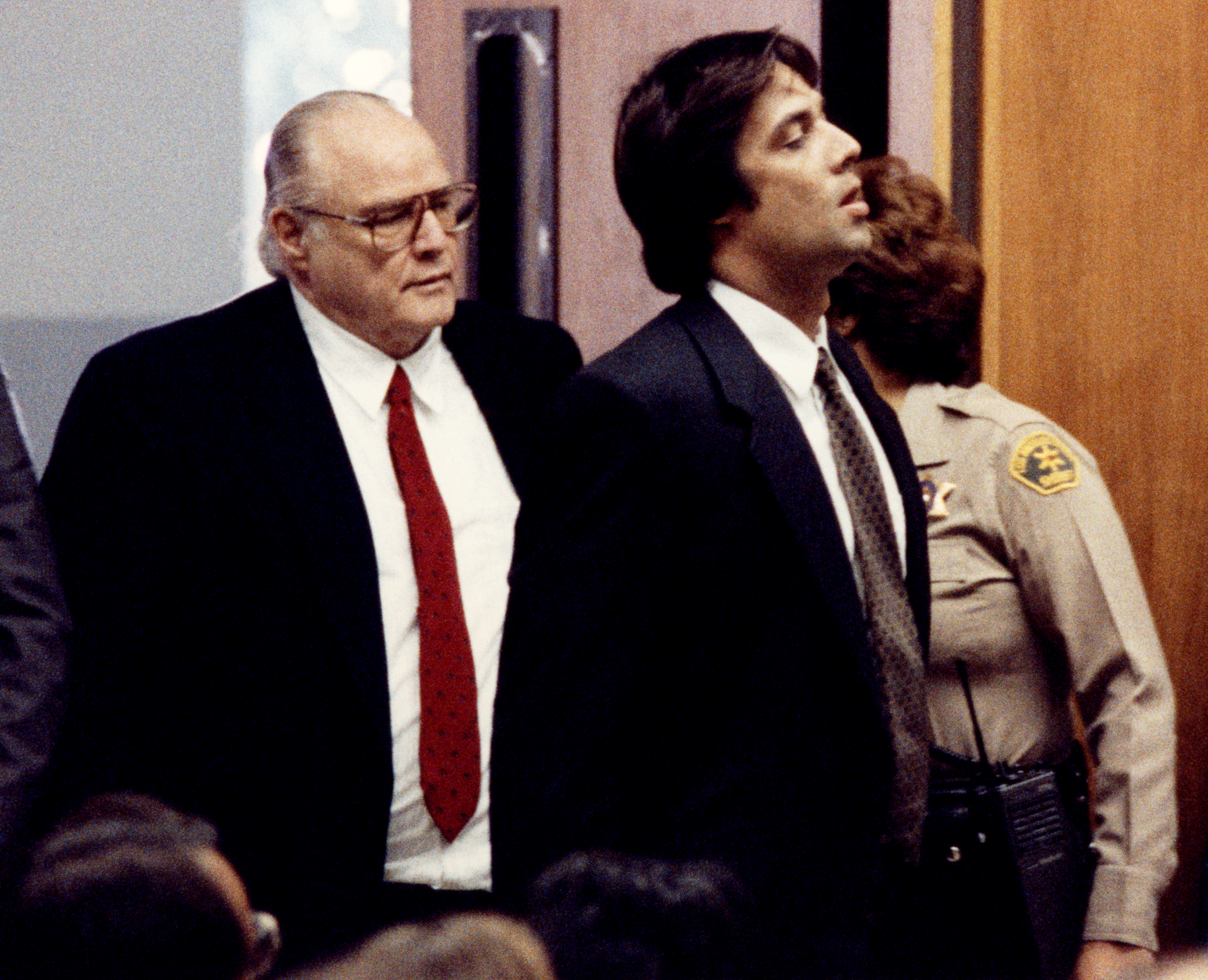 Marlon Brando and his son Christian Brando entering the courtroom during Christian's trial for the murder of Dag Drollet, circa 1990 in Santa Monica, California | Source: Getty Images