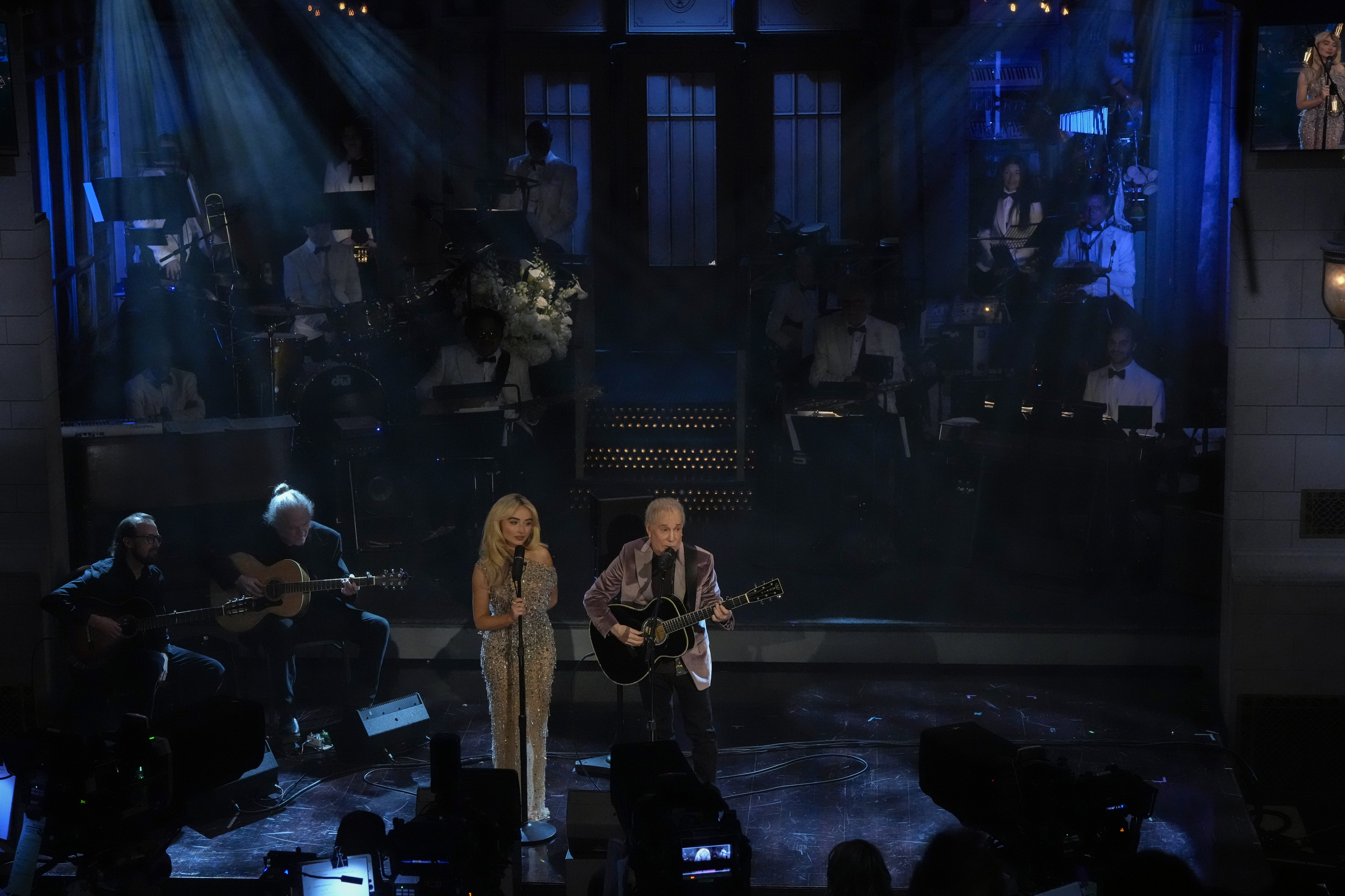 Sabrina Carpenter and Paul Simon performing during "SNL50: The Anniversary Special" on February 16, 2025. | Source: Getty Images