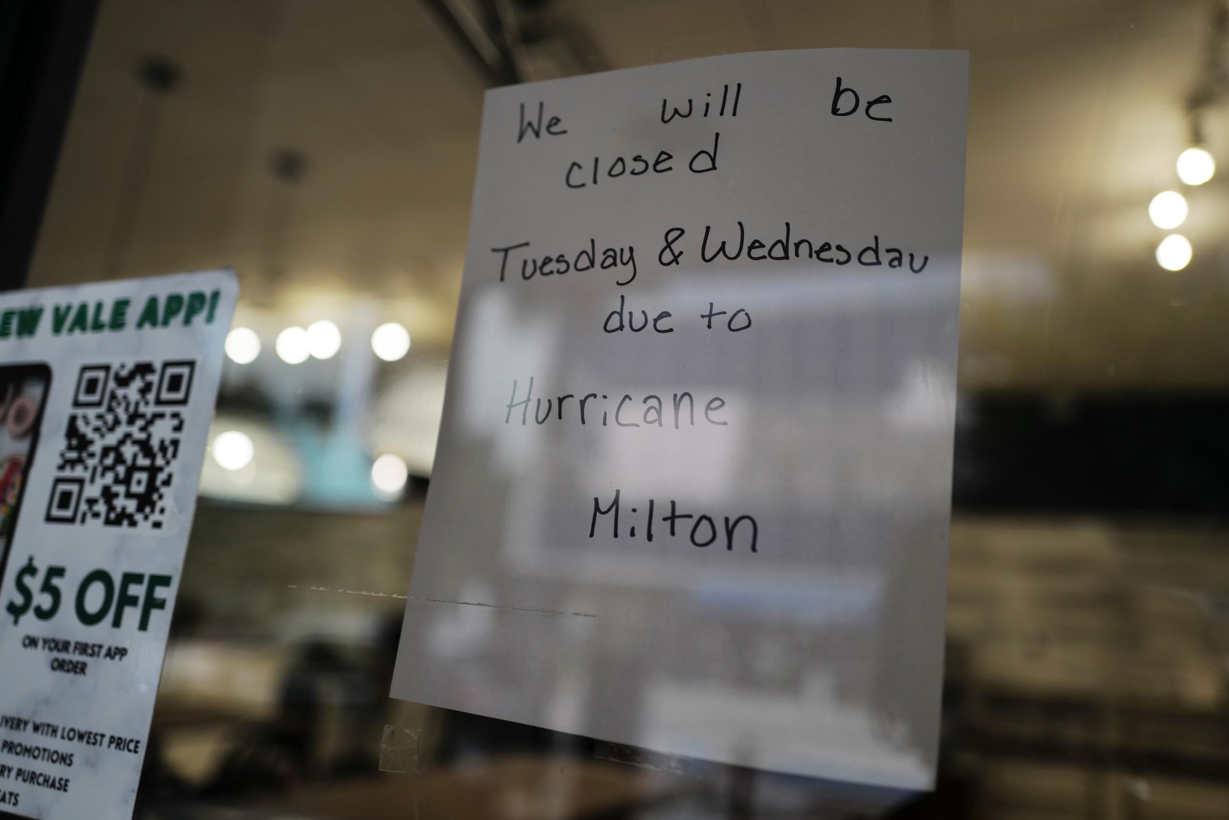 A sign alerts customers that a store will be closed as Hurricane Milton churns, on October 7, 2024 | Source: Getty Images