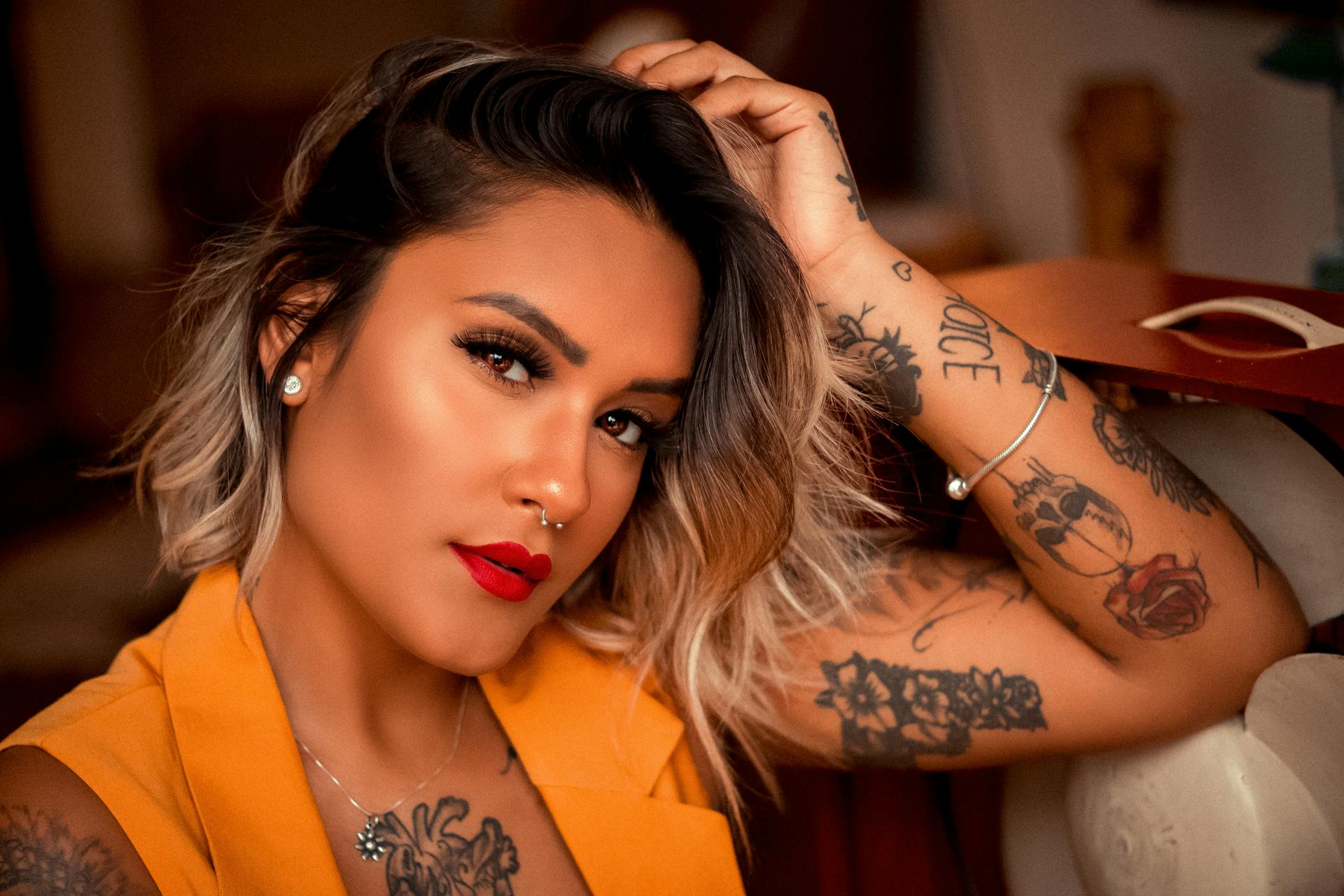 A woman with red lipstick and tattoos | Source: Pexels