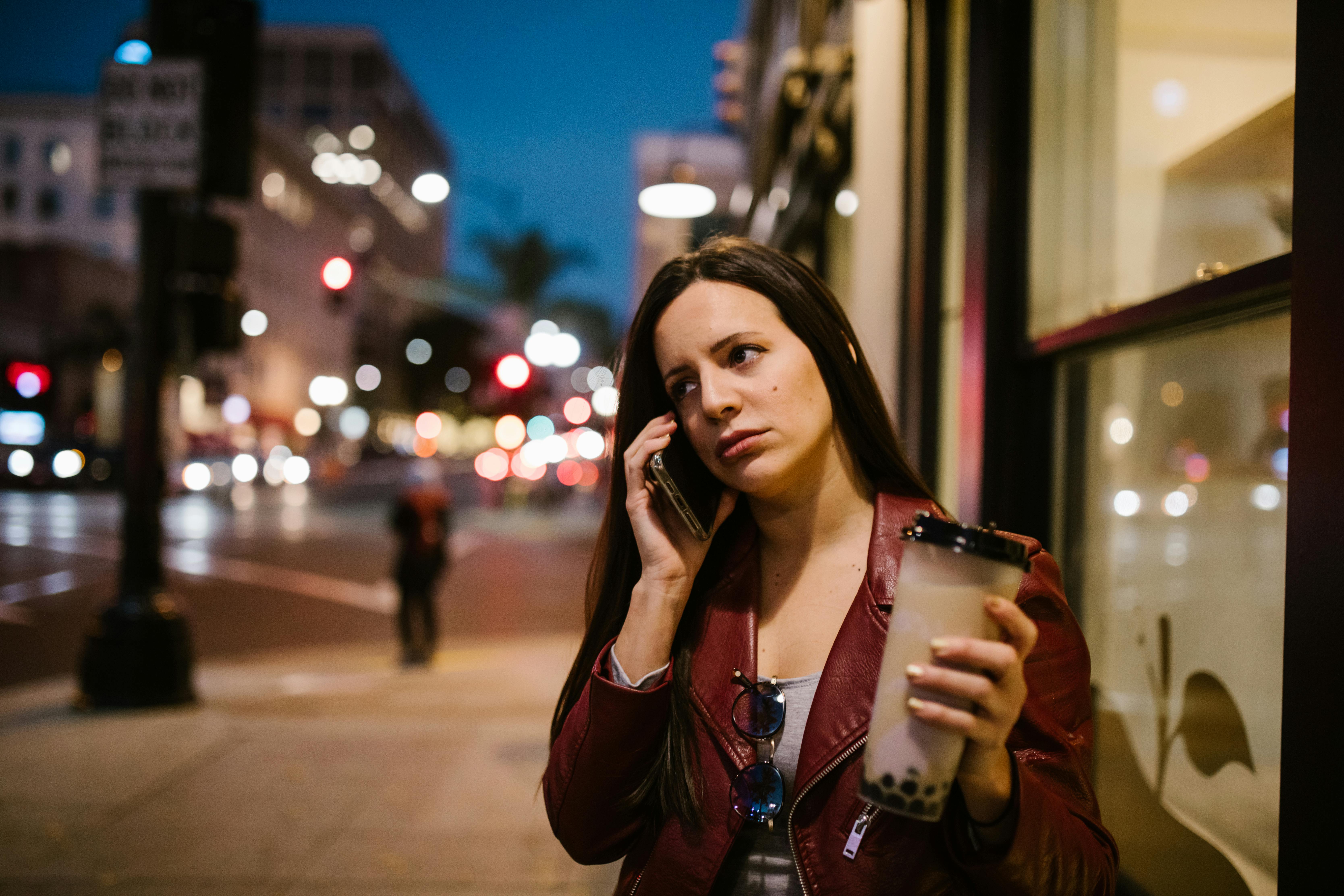 A woman on the phone in on a sidewalk | Source: Pexels