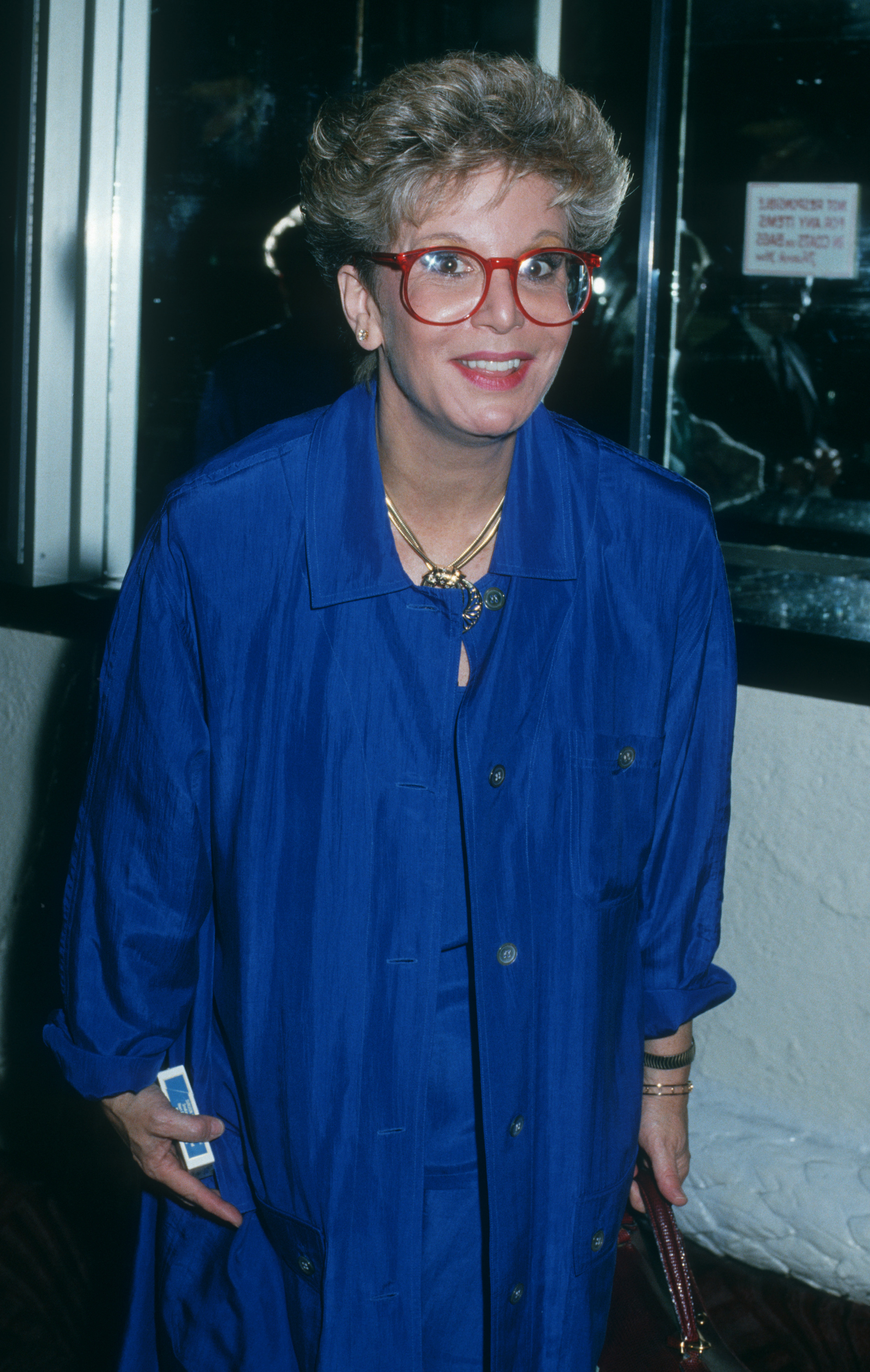 Sally Jessy Raphael arrives at the National Academy of Recording Arts and Sciences Luncheon at the Copacabana in New York City on June 2, 1988, sporting her signature red eyeglasses and a striking cobalt blue outfit.
