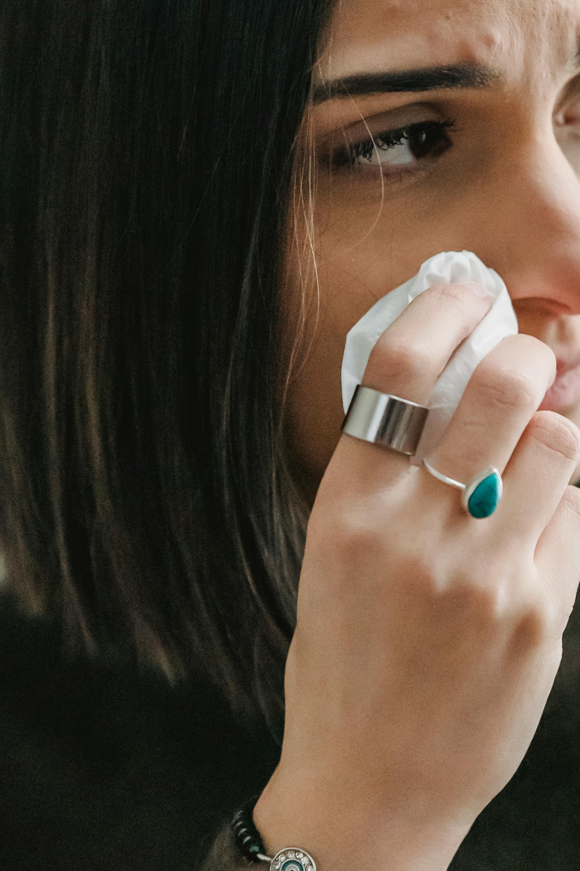 A woman wiping her cheek | Source: Pexels