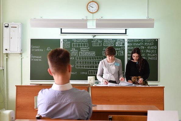 Teachers and a secondary school student  in classroom preparing for an exam | Photo: Getty Images