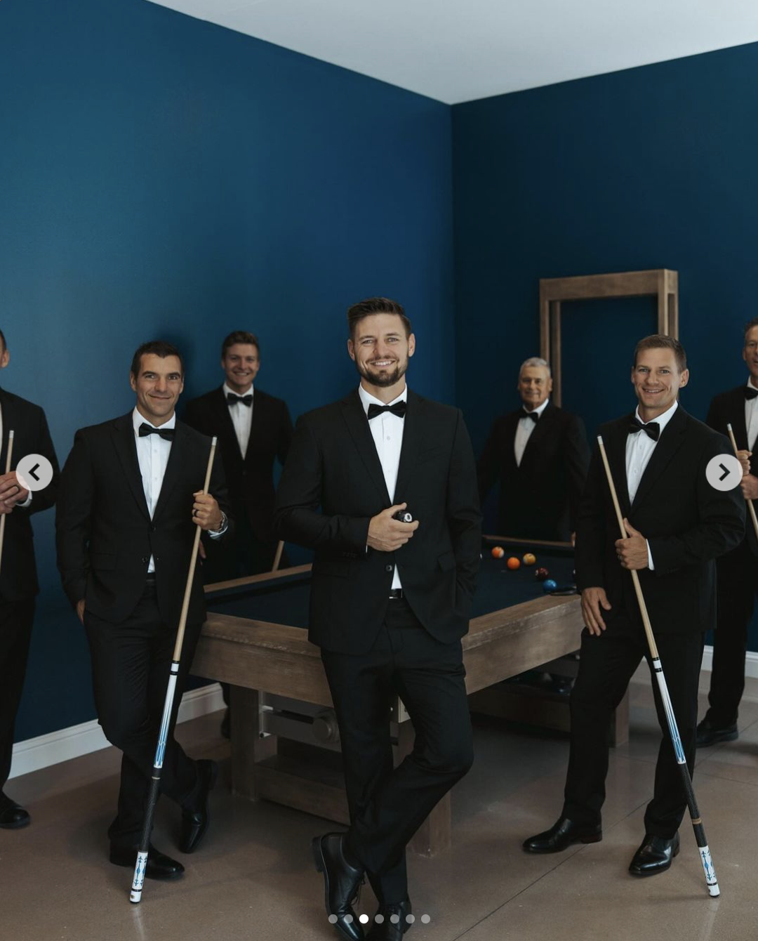 Stephen Wissmann looks suave in his black and white suit while posing with his groomsmen at a billiard table, posted in August 2024 Source: Instagram/janamduggar