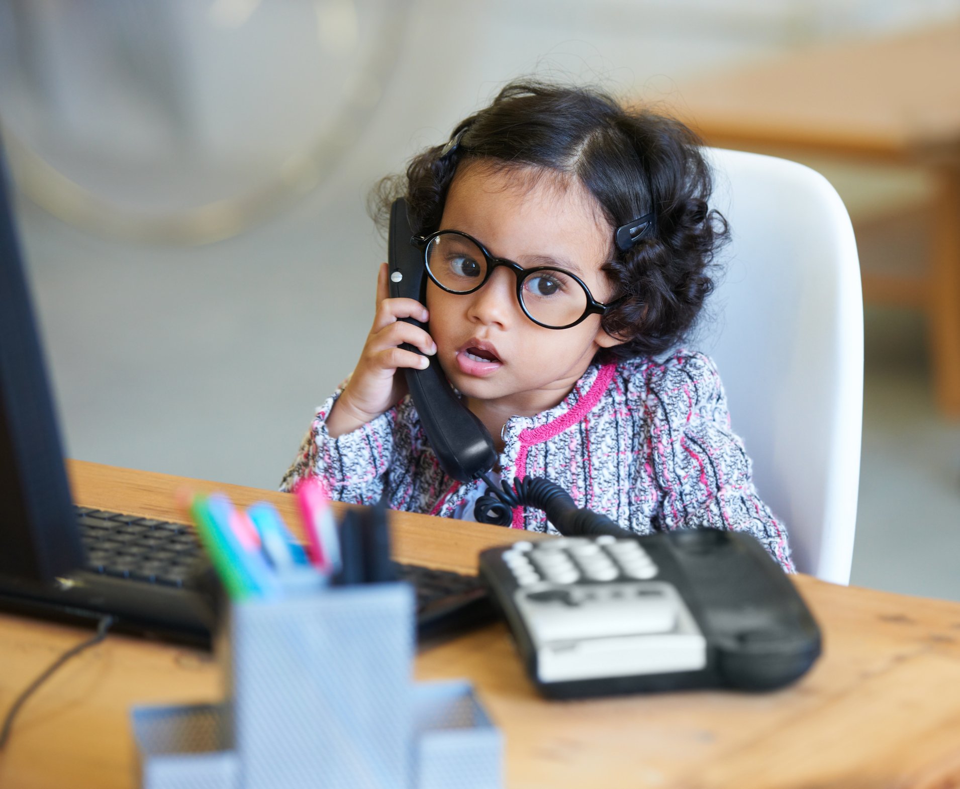 A cute little girl talking on the telephone. | Photo: Getty Images