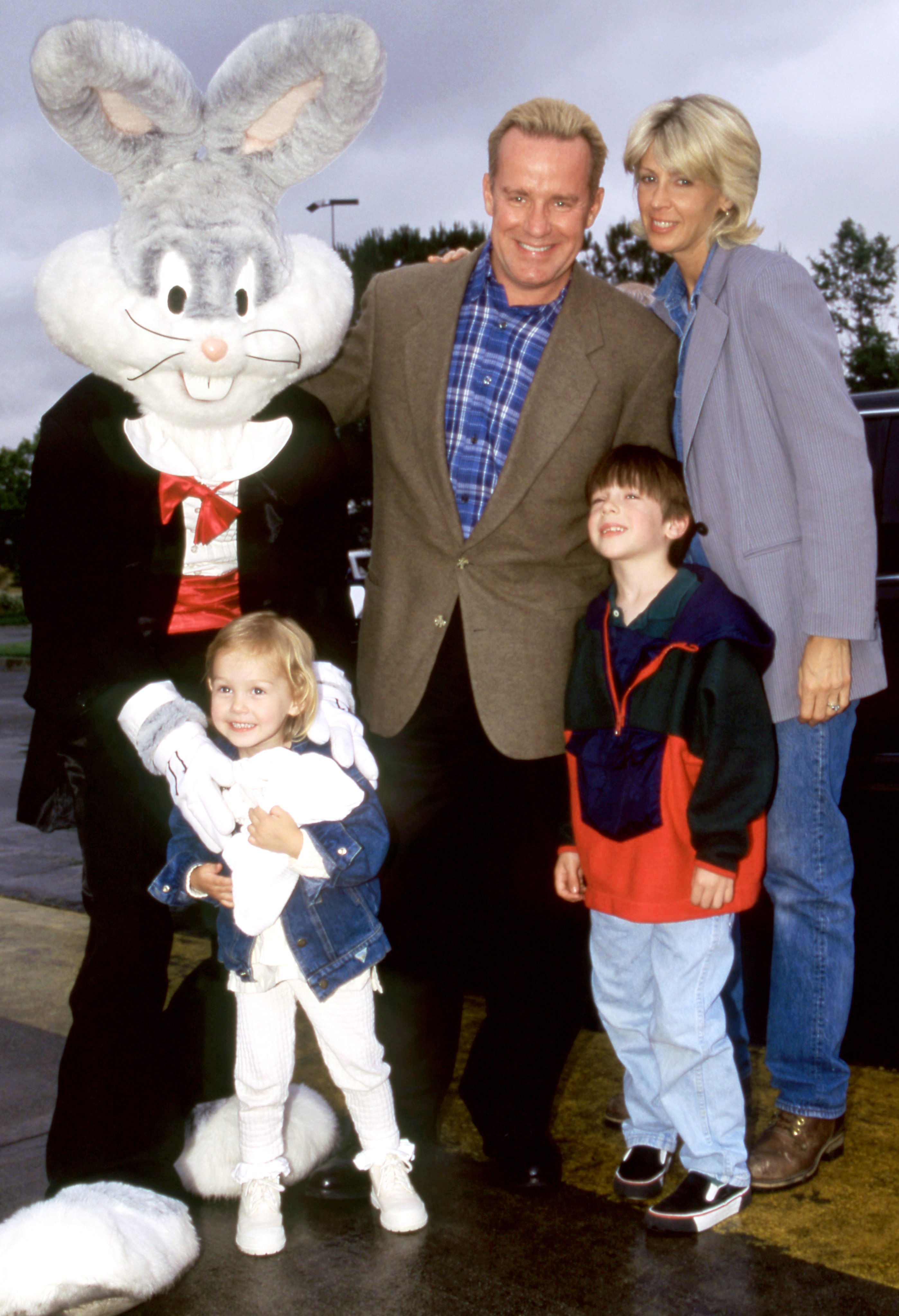  Phil Hartman his wife Brynn, his daughter and son, Birgen and Sean, pose for a portrait with Bugs Bunny during an event at Six Flags Magic Mountain in June 1995, in Valencia, California | Source: Getty Images