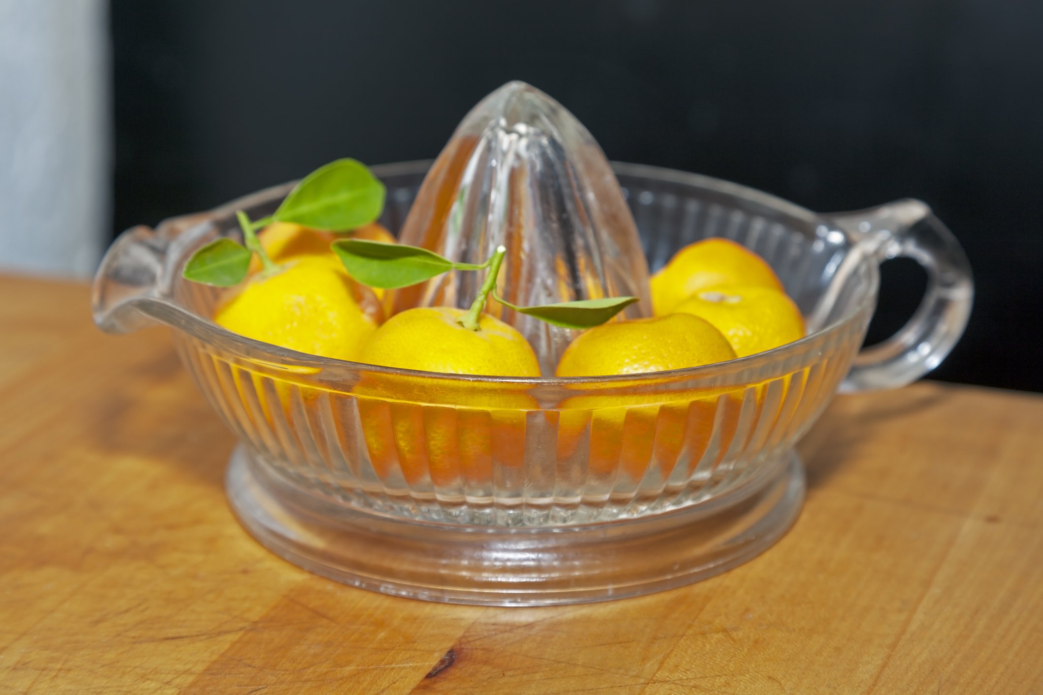 Photo of Calamondin oranges arranged in vintage juicer | Getty Images