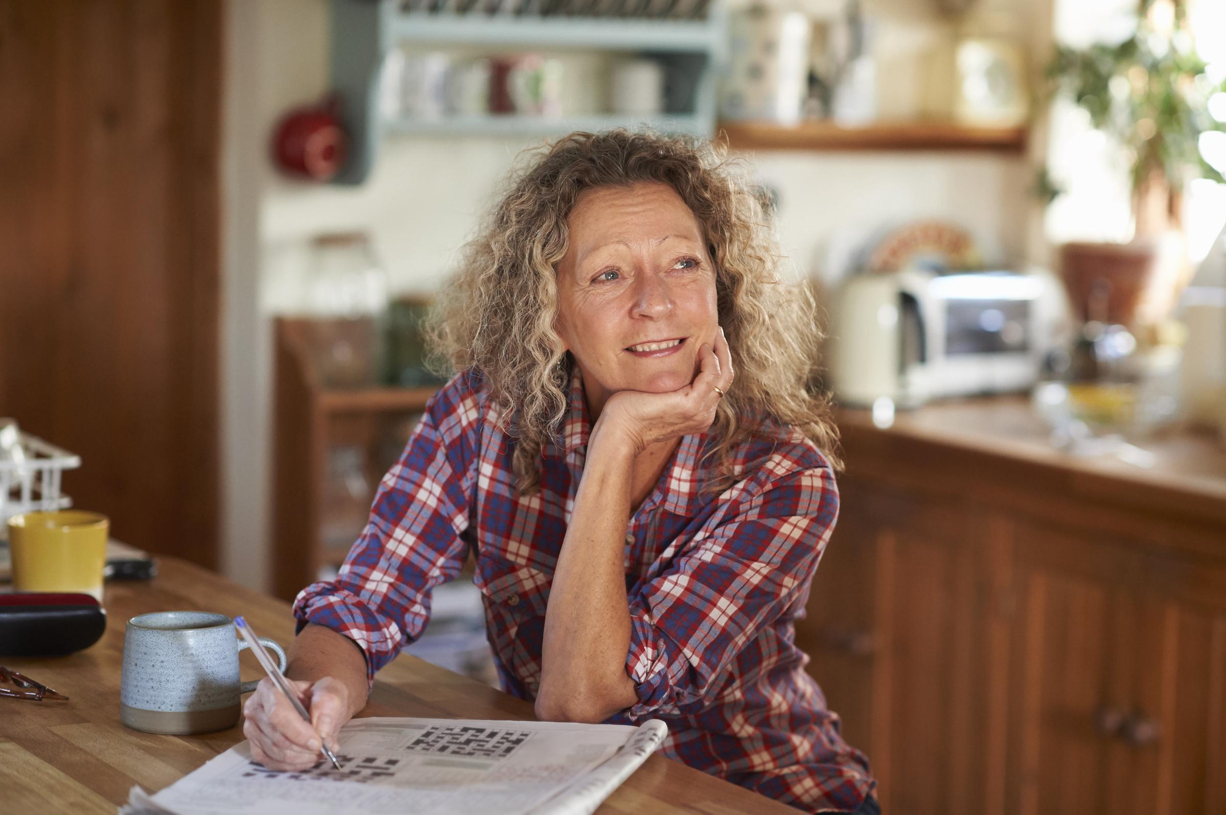A woman enjoying a crossword puzzle | Source: Getty Images