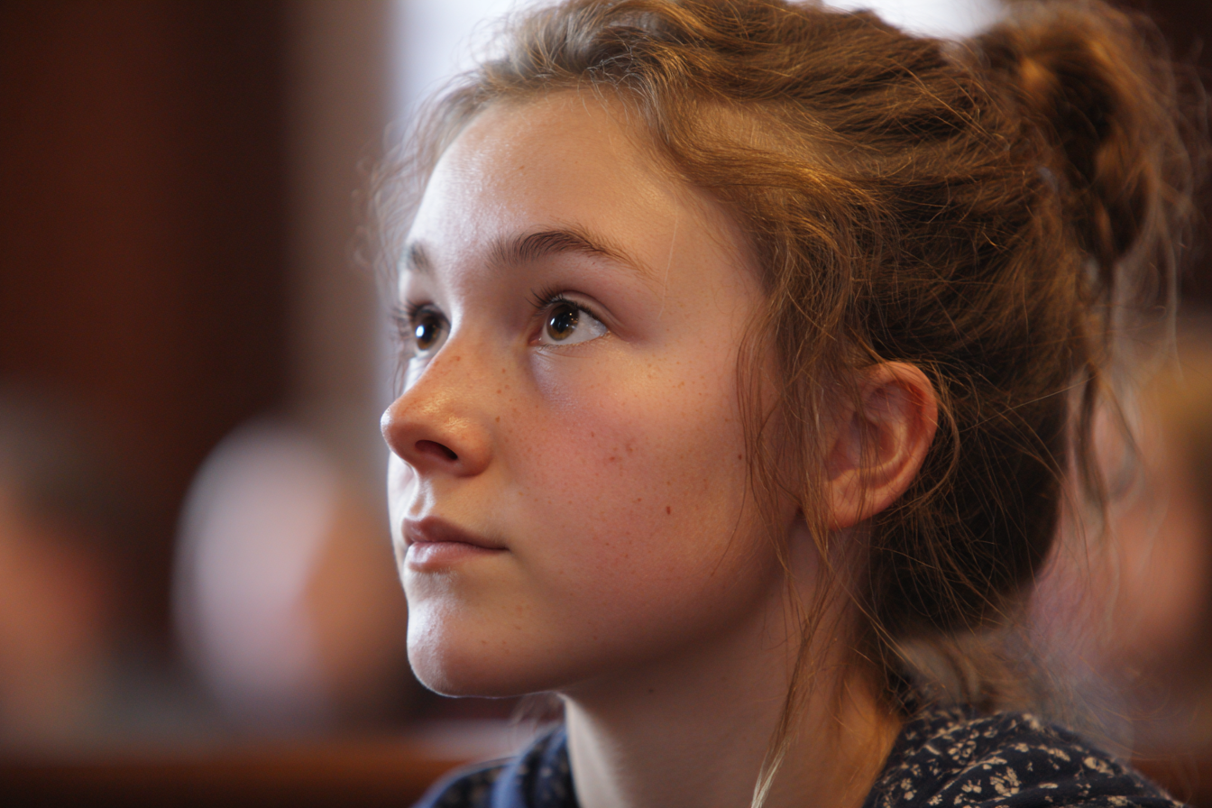 A girl standing in a courtroom | Source: Midjourney