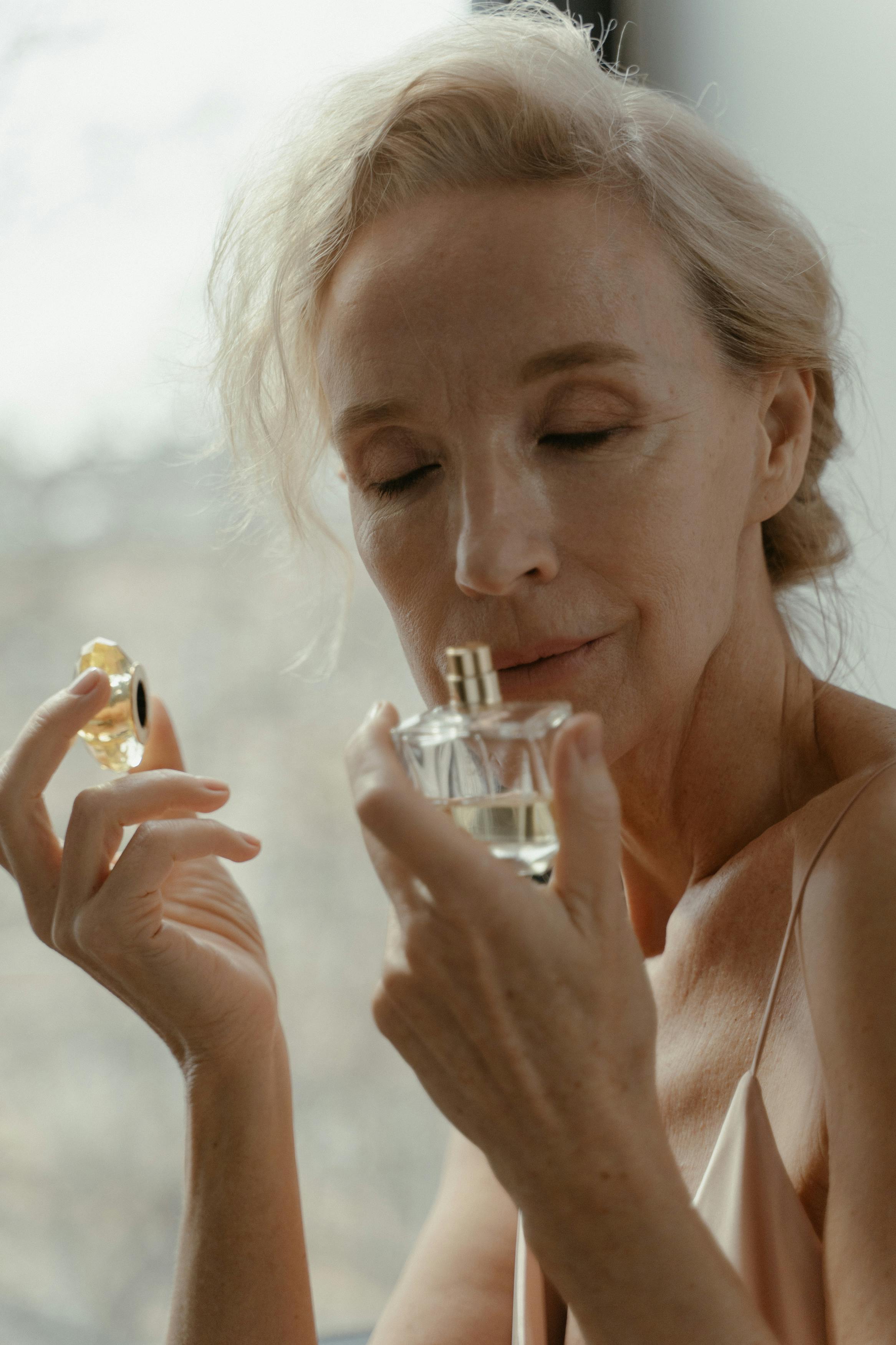A senior woman smelling perfume | Source: Pexels