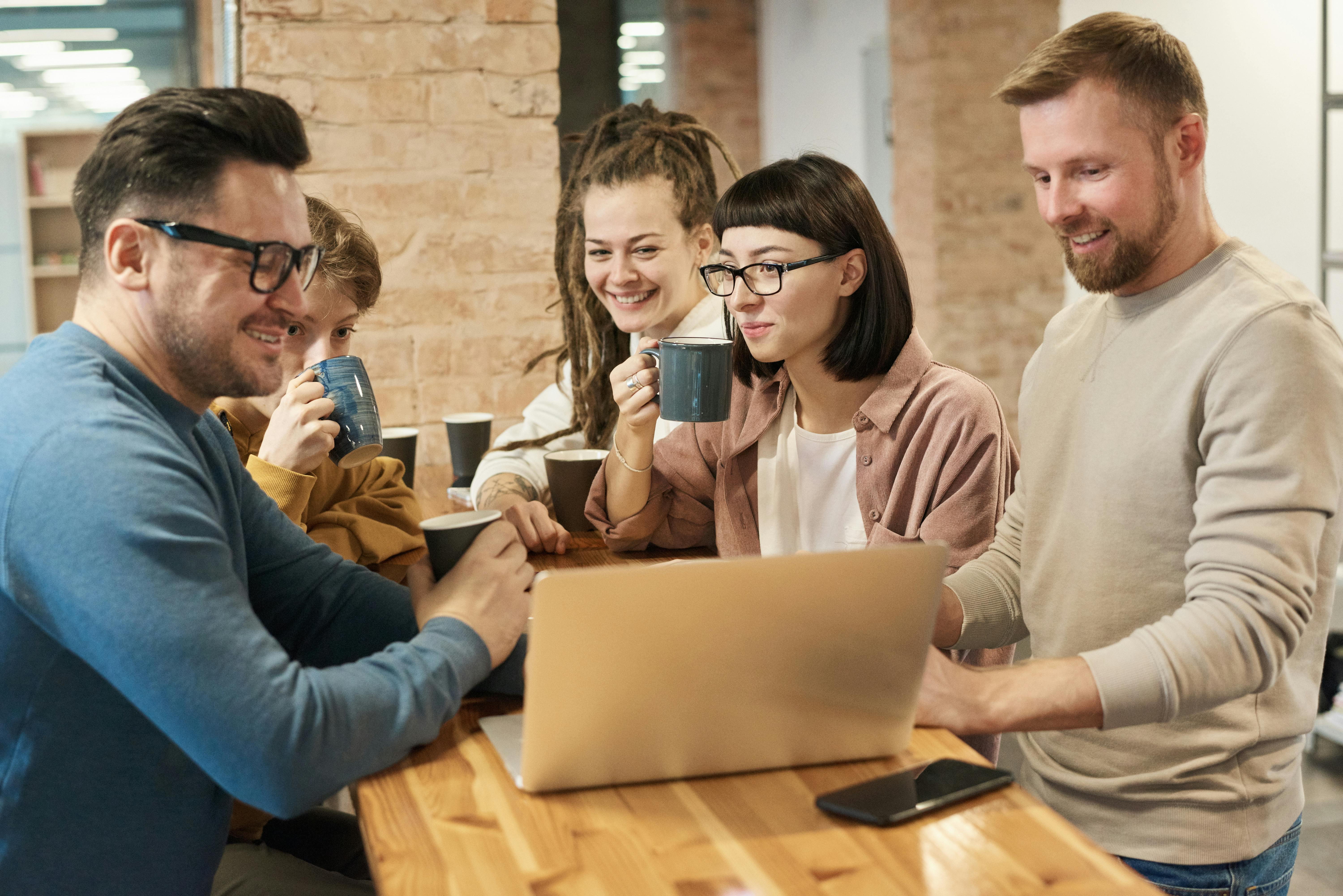 Officemates drinking coffee | Source: Pexels